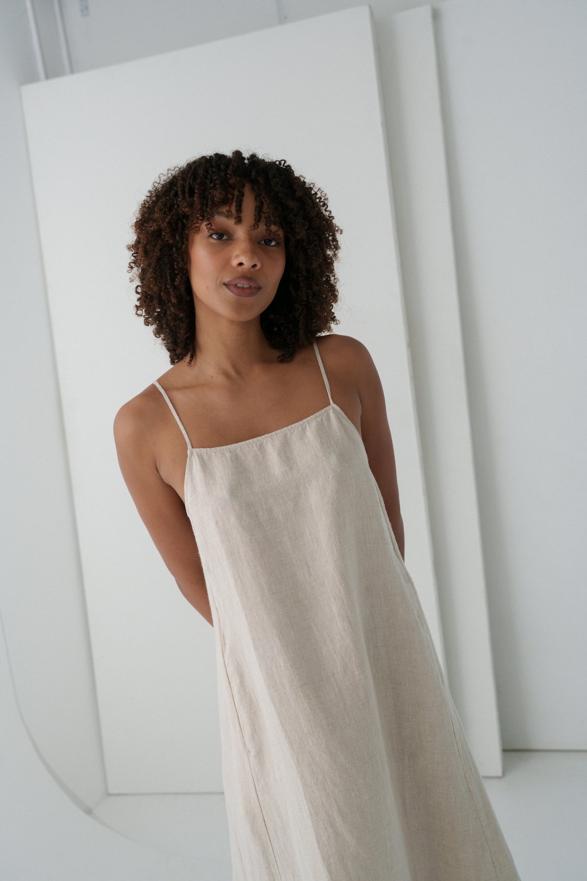 LILLY PILLY woman wearing a oatmeal Coco linen dress close up view with a white background