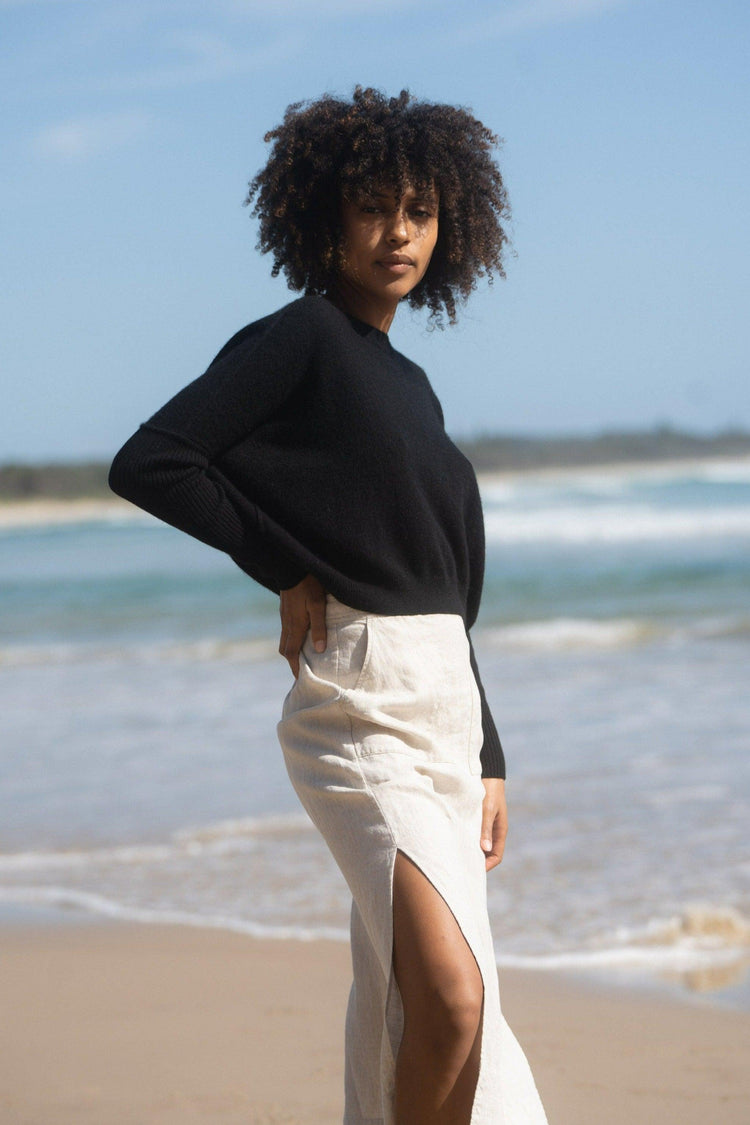 Miri Cashmere Knit in Black - three quarter view while standing on the water's edge - Lilly Pilly Collection