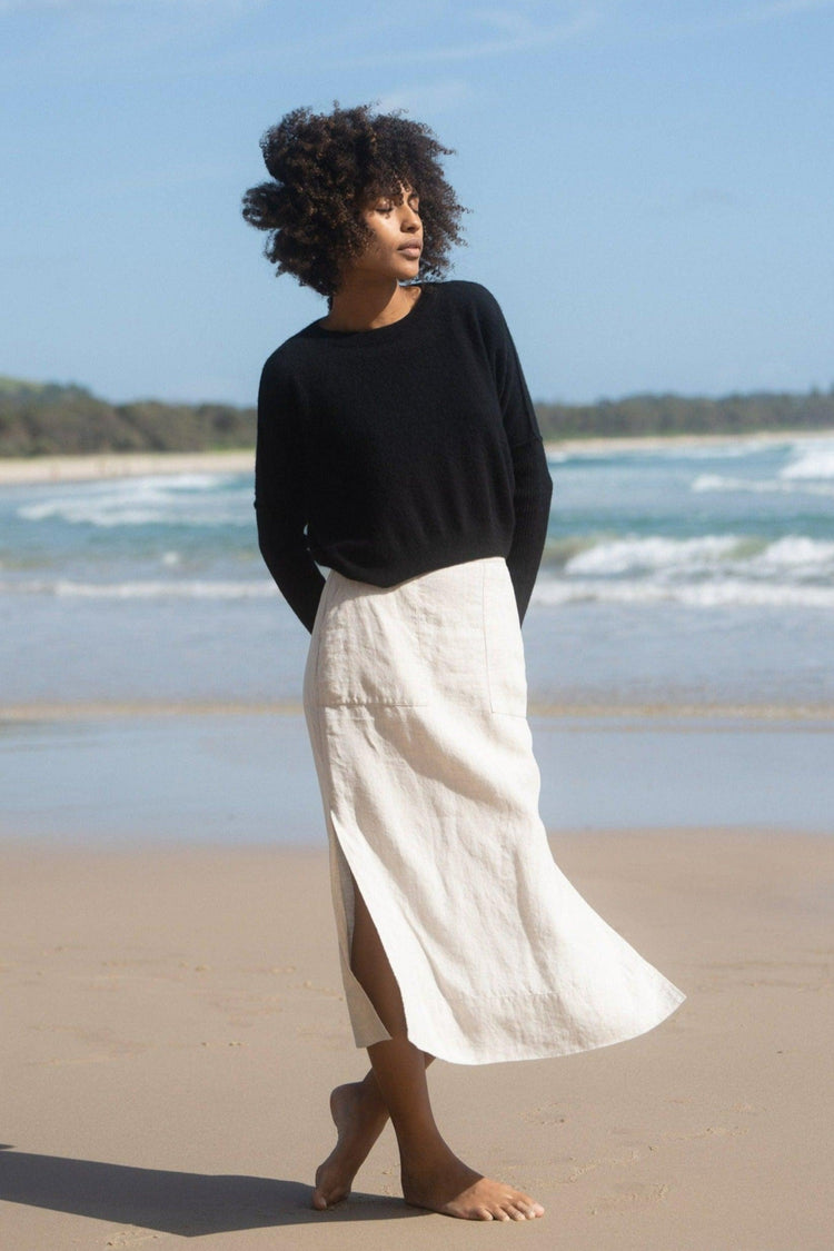 Miri Cashmere Knit in Black - full front view while standing on the water's edge - Lilly Pilly Collection