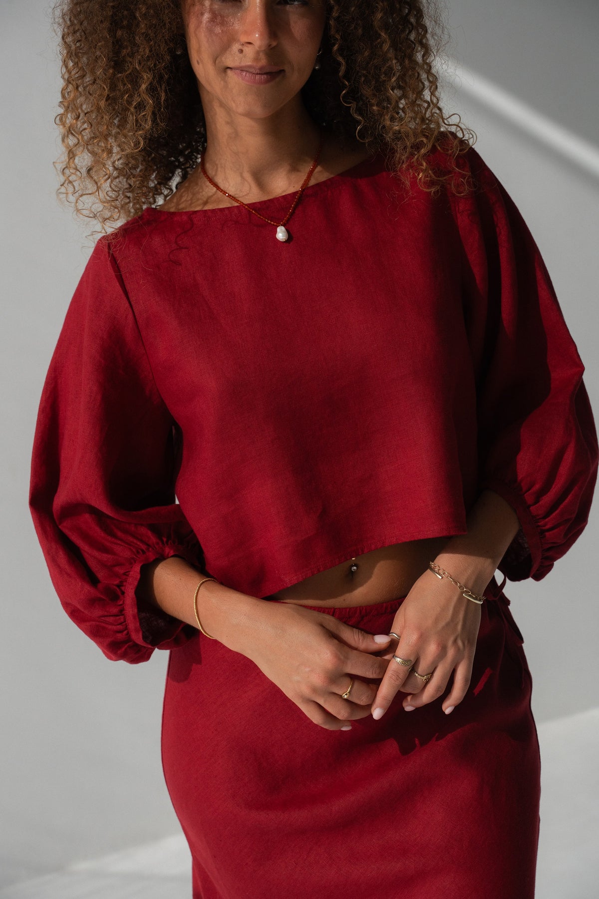 Demi Linen Top in Cherry Red - close-up of round neckline, puff sleeve and elasticated cuff detail, styled with matching Riley Linen Skirt - Lilly Pilly Collection