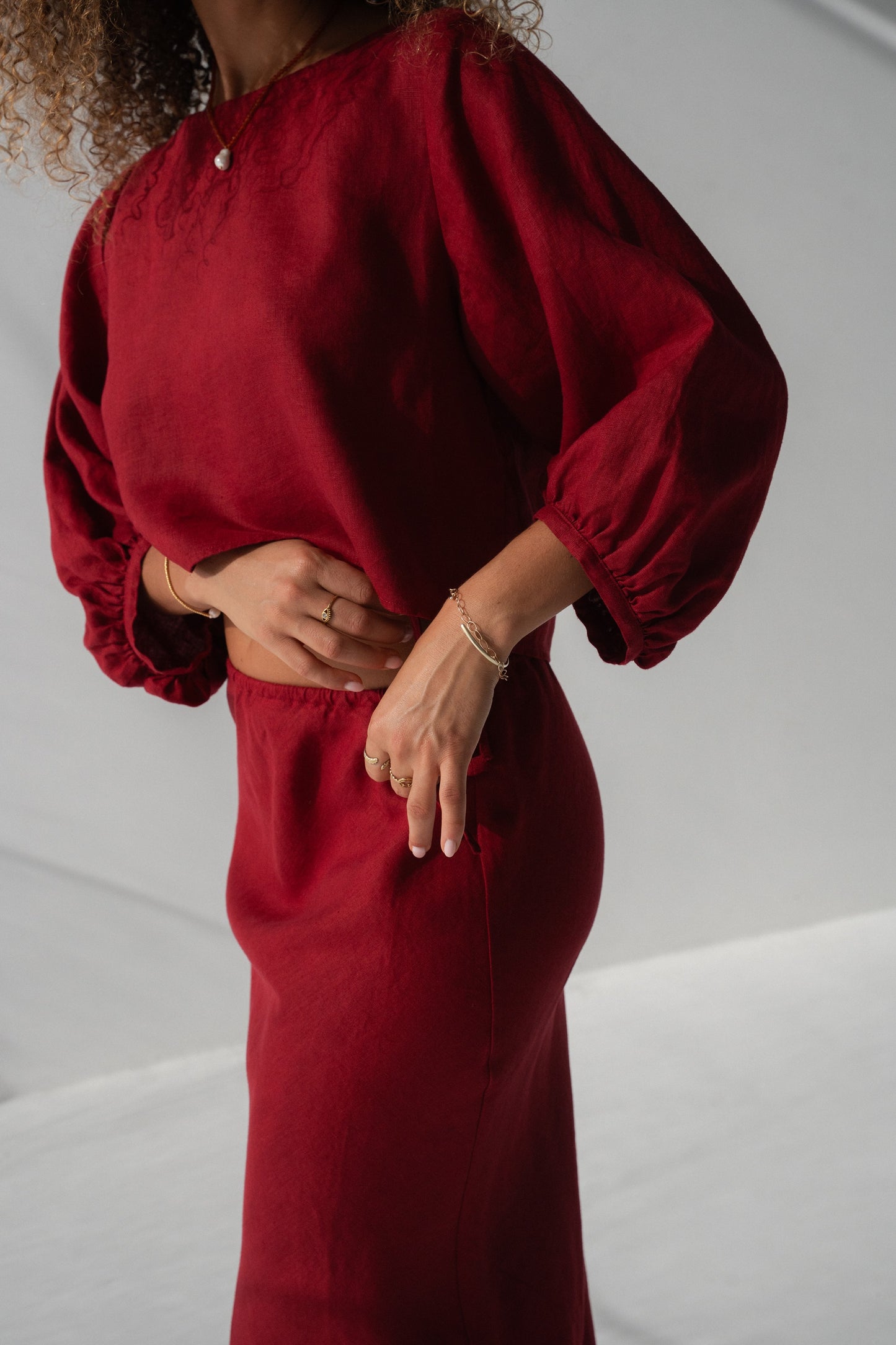 Demi Linen Top in Cherry Red - side close-up of puff sleeve, elasticated cuff and cropped hem detail - Lilly Pilly Collection