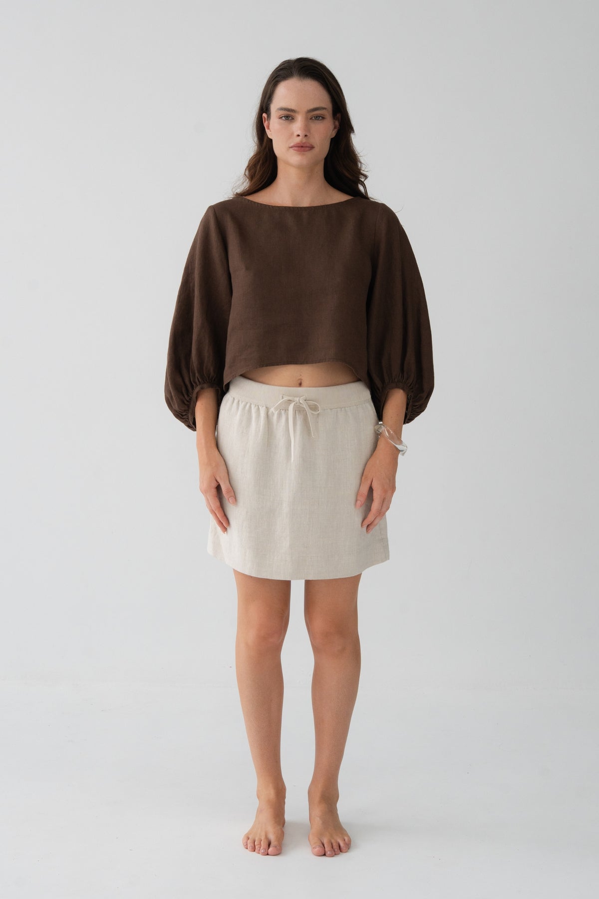 Demi Linen Top in Chocolate - front view, round neckline and puff sleeves with elasticated cuffs, styled with oatmeal linen mini skirt - Lilly Pilly Collection
