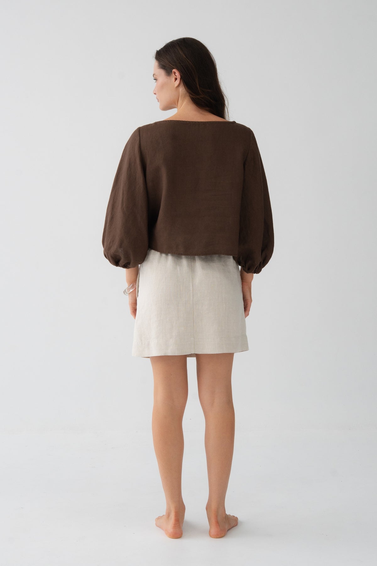 Demi Linen Top in Chocolate - back view, puff sleeves and cropped silhouette, styled with oatmeal linen mini skirt - Lilly Pilly Collection