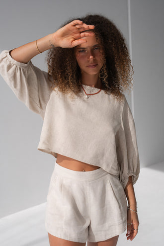 Demi Linen Top in Oatmeal - close-up front view, round neckline and puff sleeves with elasticated cuffs, styled with Gaia Linen shorts in Oatmeal - Lilly Pilly Collection