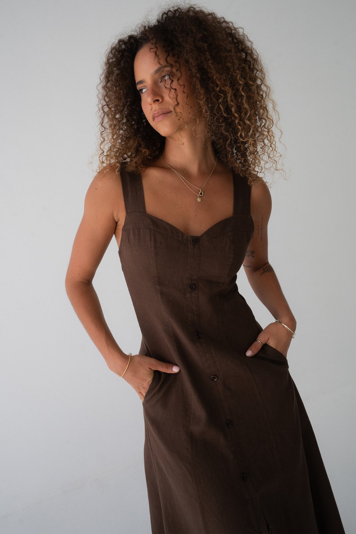 Eden Linen Midi Dress in Chocolate - three-quarter view, sweetheart neckline, hands in pockets, A-line midi silhouette - Lilly Pilly Collection