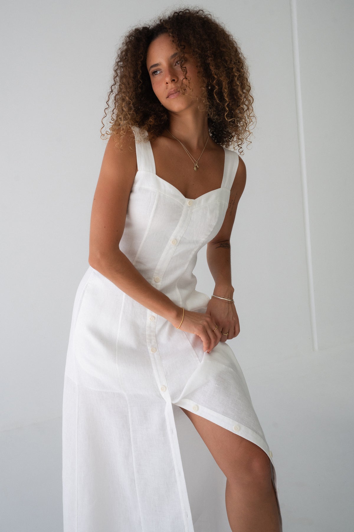 Eden Linen Midi Dress in Ivory - three-quarter view, sweetheart neckline and button-front placket, side split - Lilly Pilly Collection
