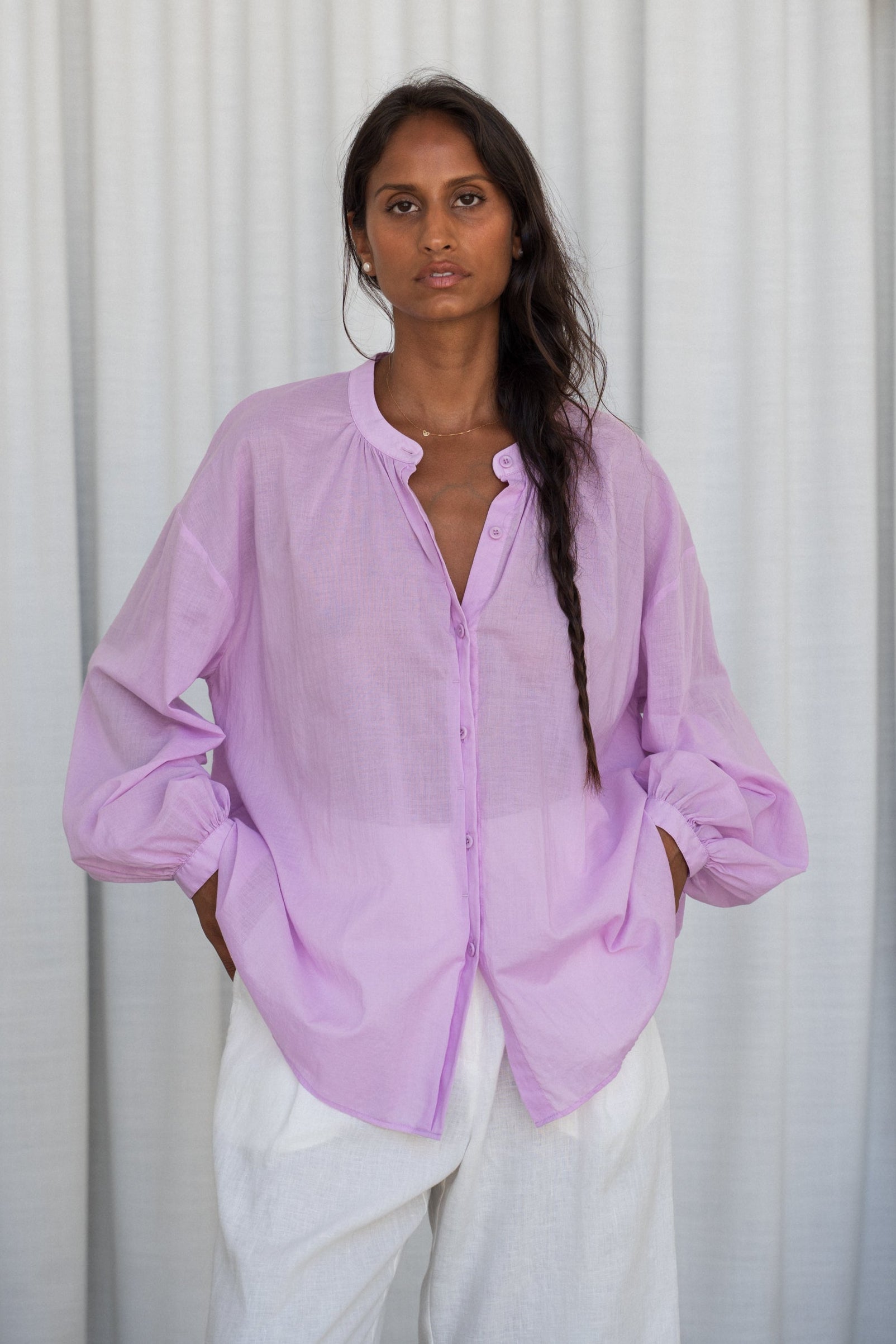 LILLY PILLY woman wearing a orchid Ember cotton voile shirt against a neutral background