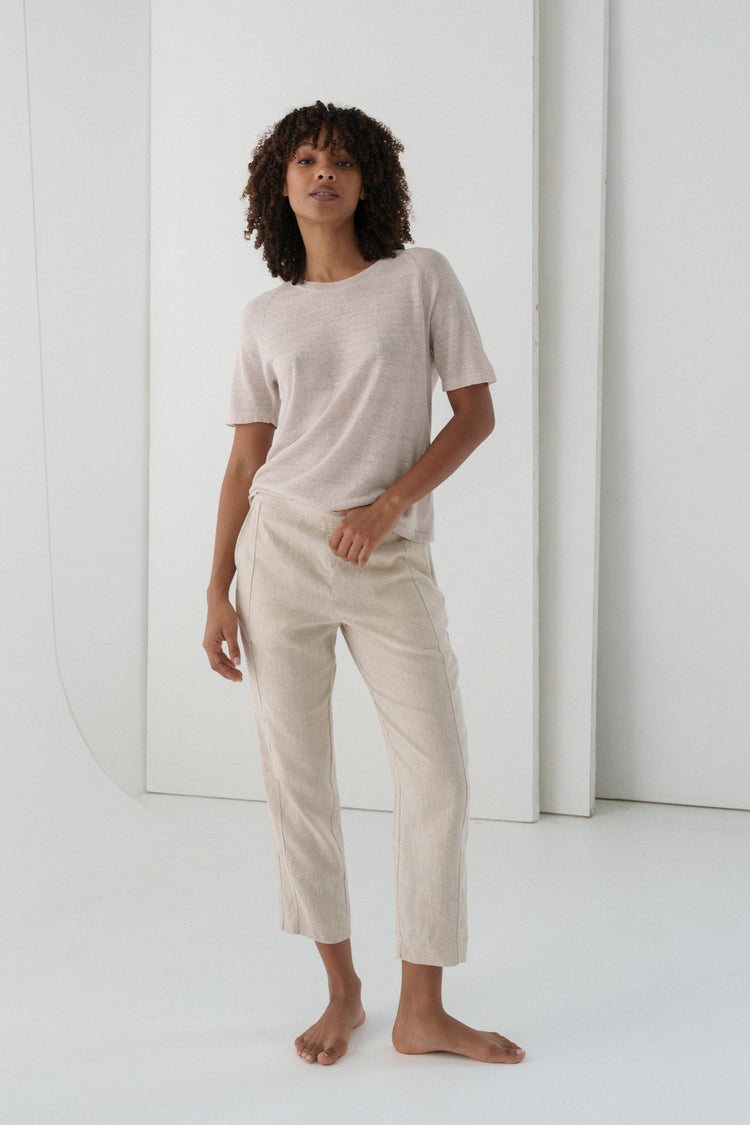 Emer Linen Pants in Oatmeal - full length front view, woman wearing Oatmeal tapered linen pants with matching linen tee, white studio backdrop - Lilly Pilly Collection