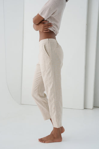 Emer Linen Pants in Oatmeal - side close-up of zip fastening and tapered linen leg silhouette, white studio backdrop - Lilly Pilly Collection