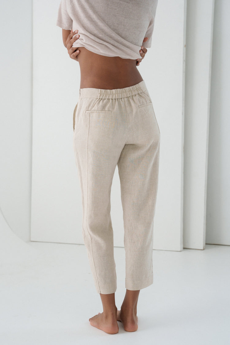 Emer Linen Pants in Oatmeal - back close-up of elasticated waistband and back patch pockets, white studio backdrop - Lilly Pilly Collection