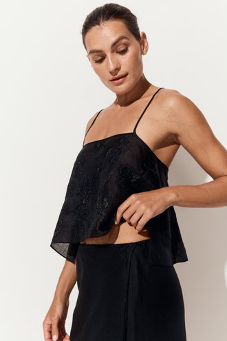 Flora Ramie Cami in Black - three-quarter view, floral embroidery and thin straps, styled with Riley Bias Linen Midi Skirt in Black, white studio - Lilly Pilly Collection