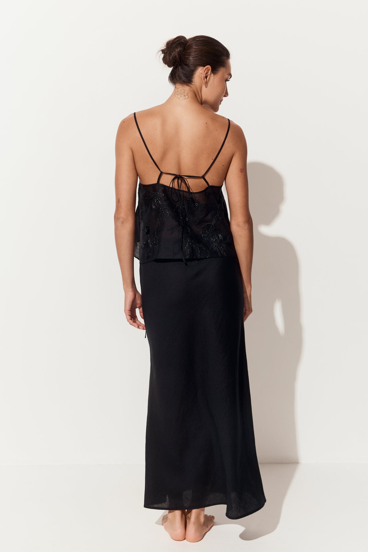 Flora Ramie Cami in Black - back view, tie-back detail and thin straps, styled with Riley Bias Linen Midi Skirt in Black, white studio - Lilly Pilly Collection