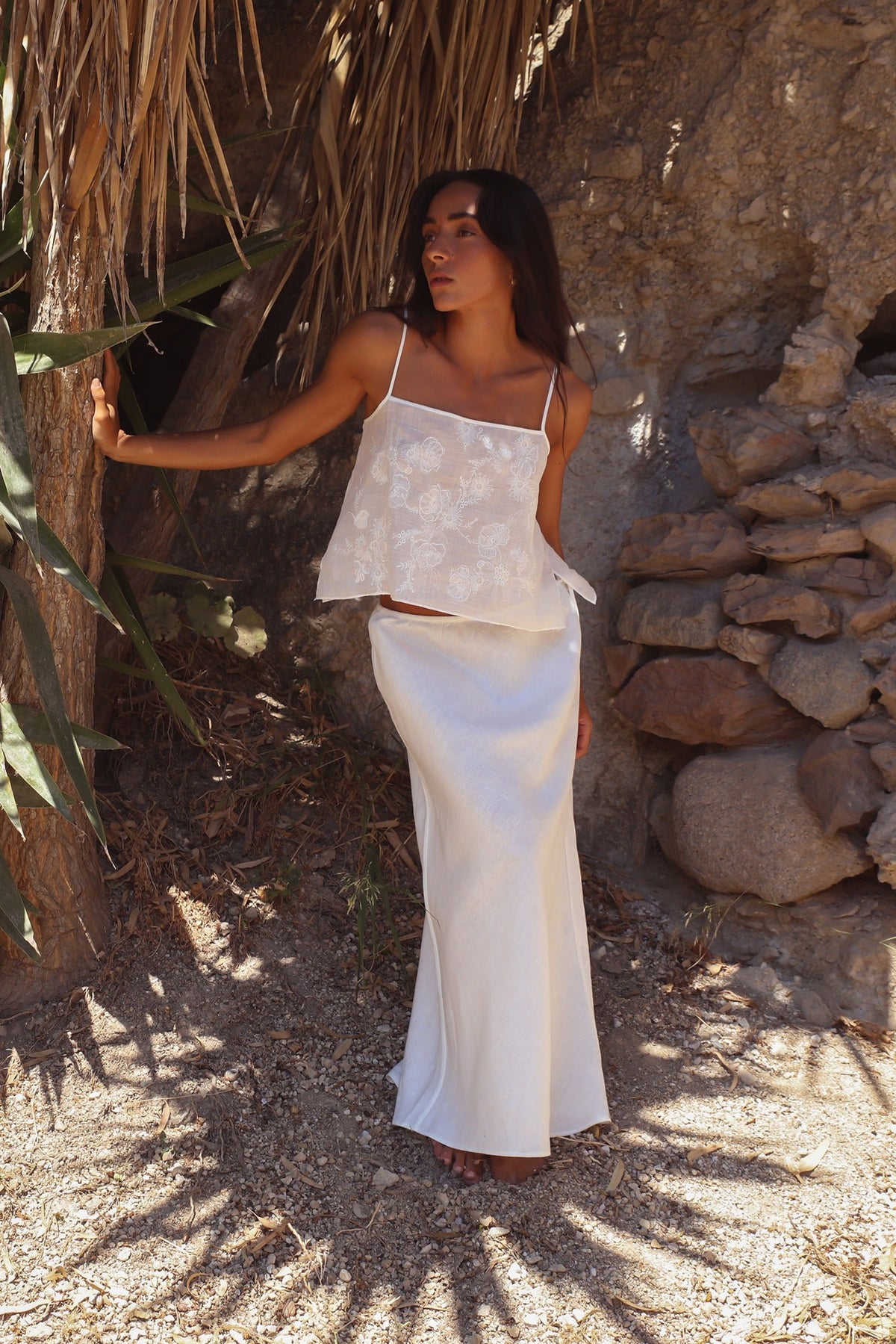 Flora Ramie Cami in Ivory - full length, floral embroidery and thin straps, worn with Riley Bias Linen Midi Skirt in Ivory, stone wall backdrop - Lilly Pilly Collection