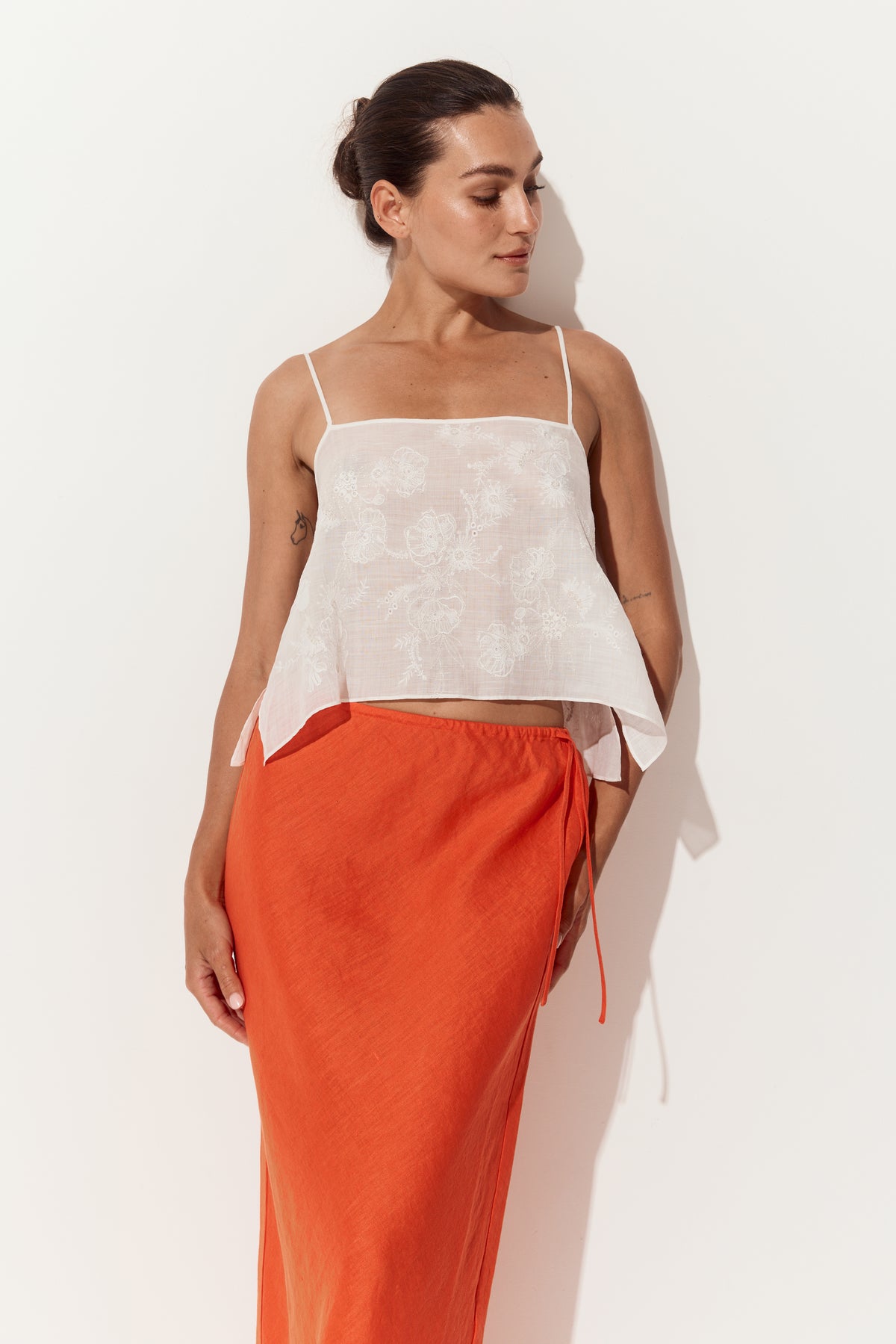 Flora Ramie Cami in Ivory - three-quarter view, floral embroidery, styled with Riley Bias Linen Midi Skirt in Spritz Orange - Lilly Pilly Collection
