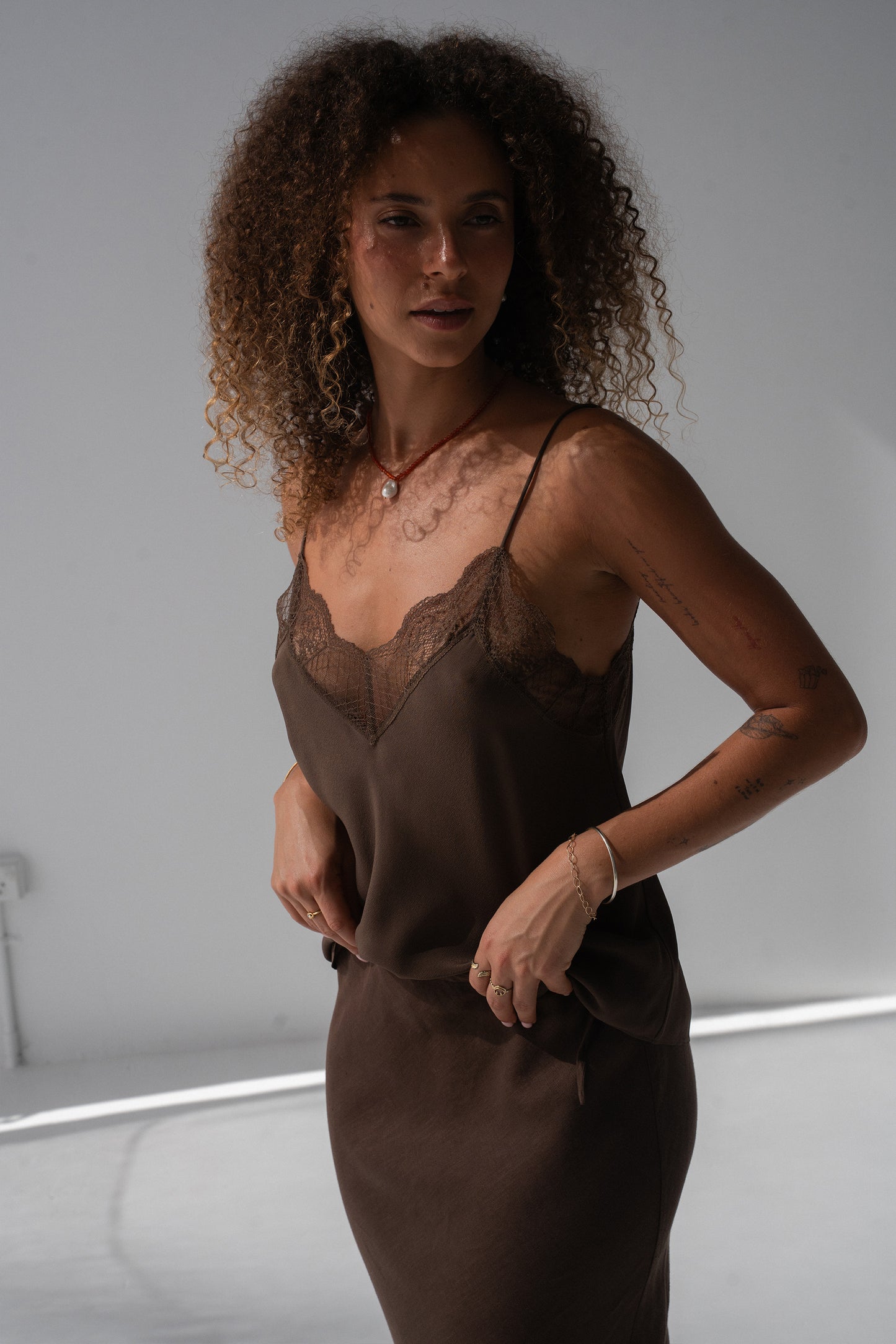 Frankie Silk Cami in Chocolate - three-quarter view, V-neckline and lace trim, styled with chocolate linen midi skirt - Lilly Pilly Collection