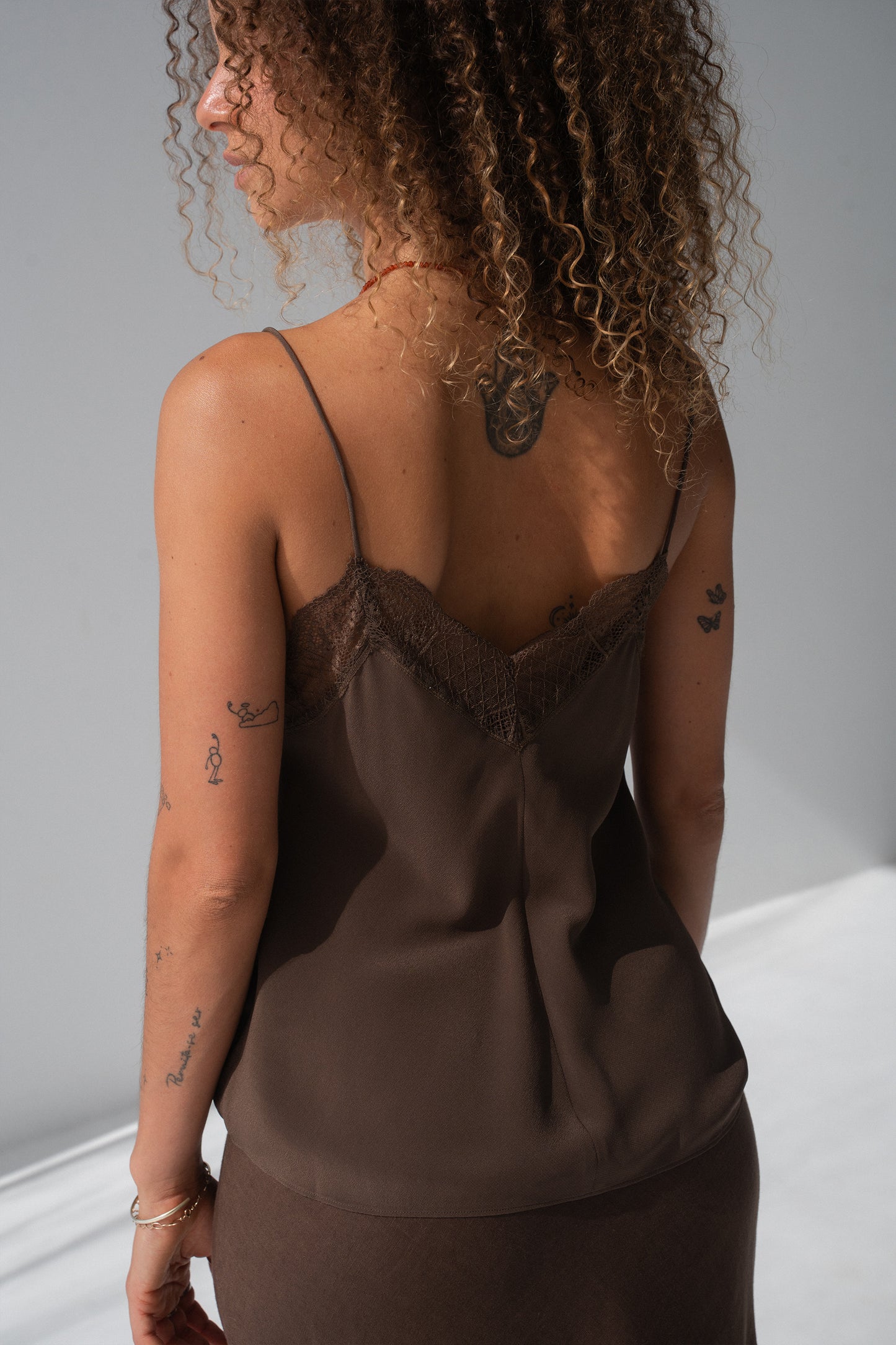 Frankie Silk Cami in Chocolate - back view, spaghetti straps and lace trim, styled with chocolate linen midi skirt - Lilly Pilly Collection