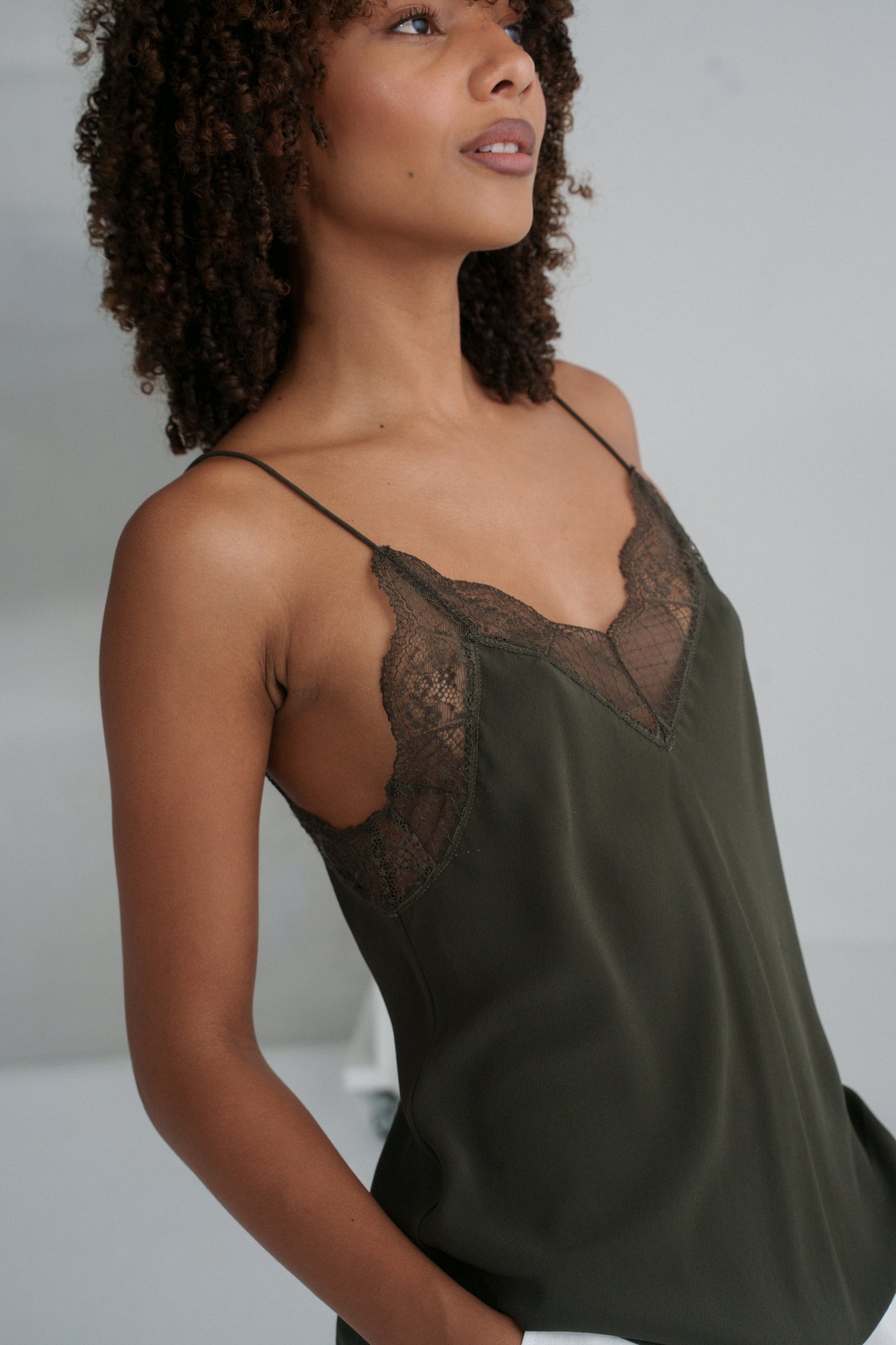 LILLY PILLY woman wearing Frankie silk cami in khaki in studio