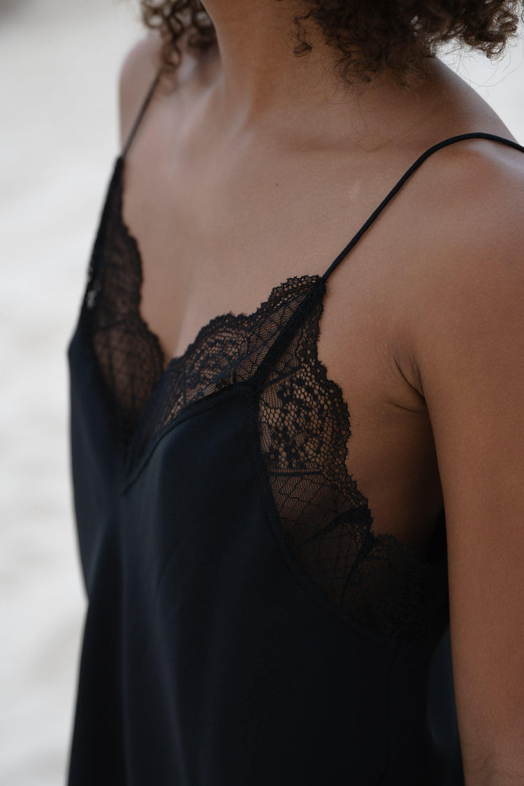 Frankie Silk Cami in Black - close-up of V-neckline and lace trim detail, beach - Lilly Pilly Collection
