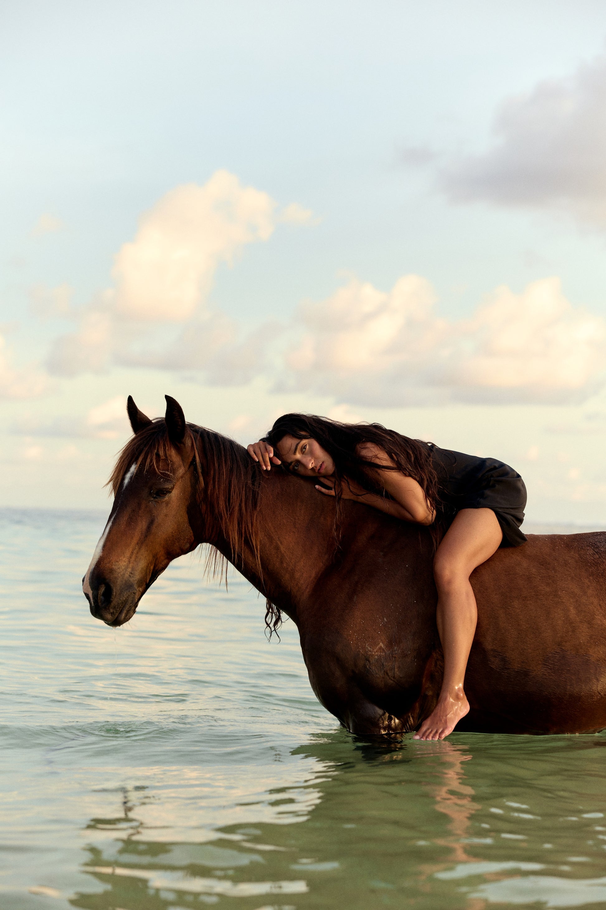 Freya Black Silk Slip Dress - woman seated on a horse, lace V-neckline, outdoor setting - Lilly Pilly Collection