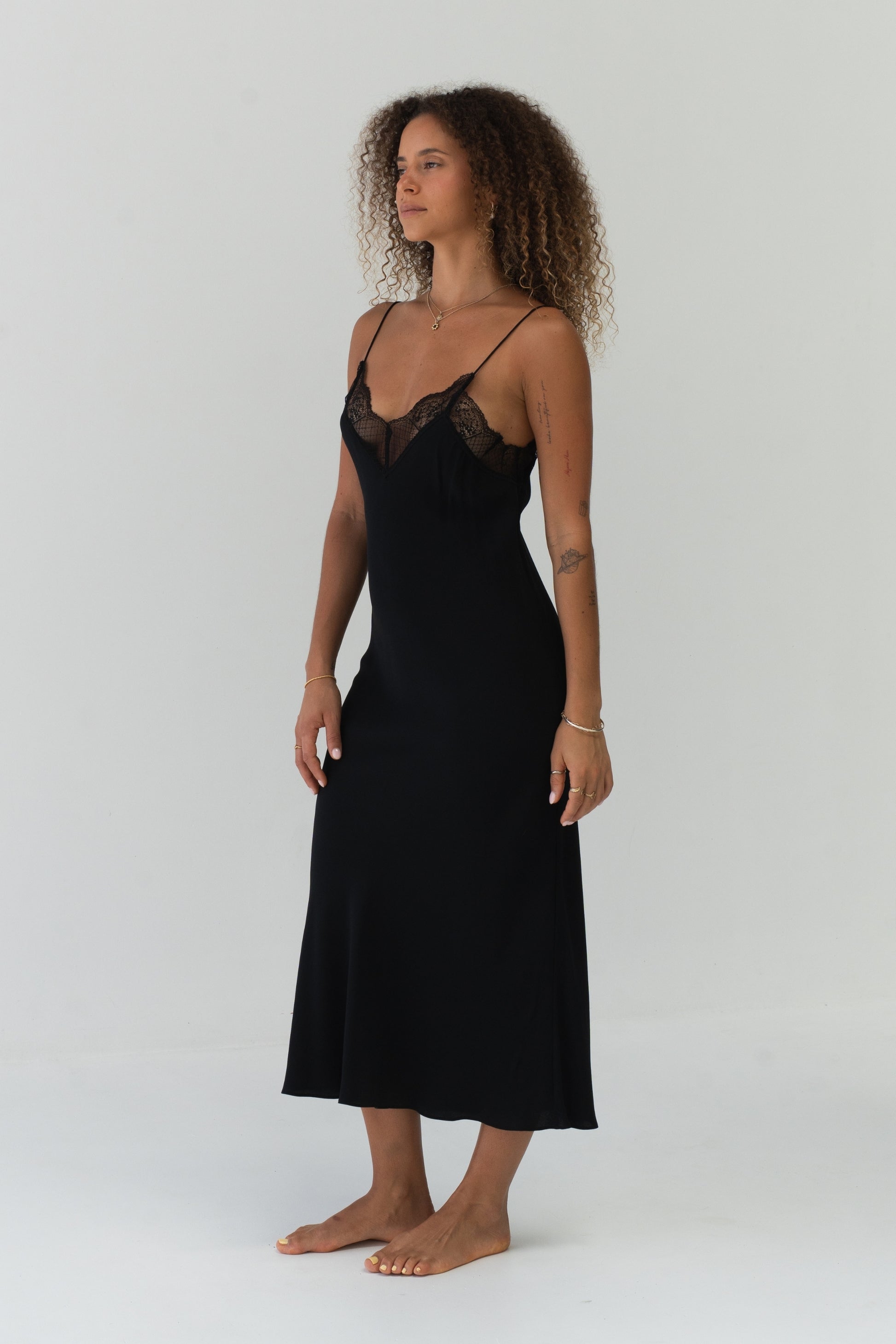 Freya Black Silk Slip Dress - side profile, fluid silk drape and midi length - Lilly Pilly Collection