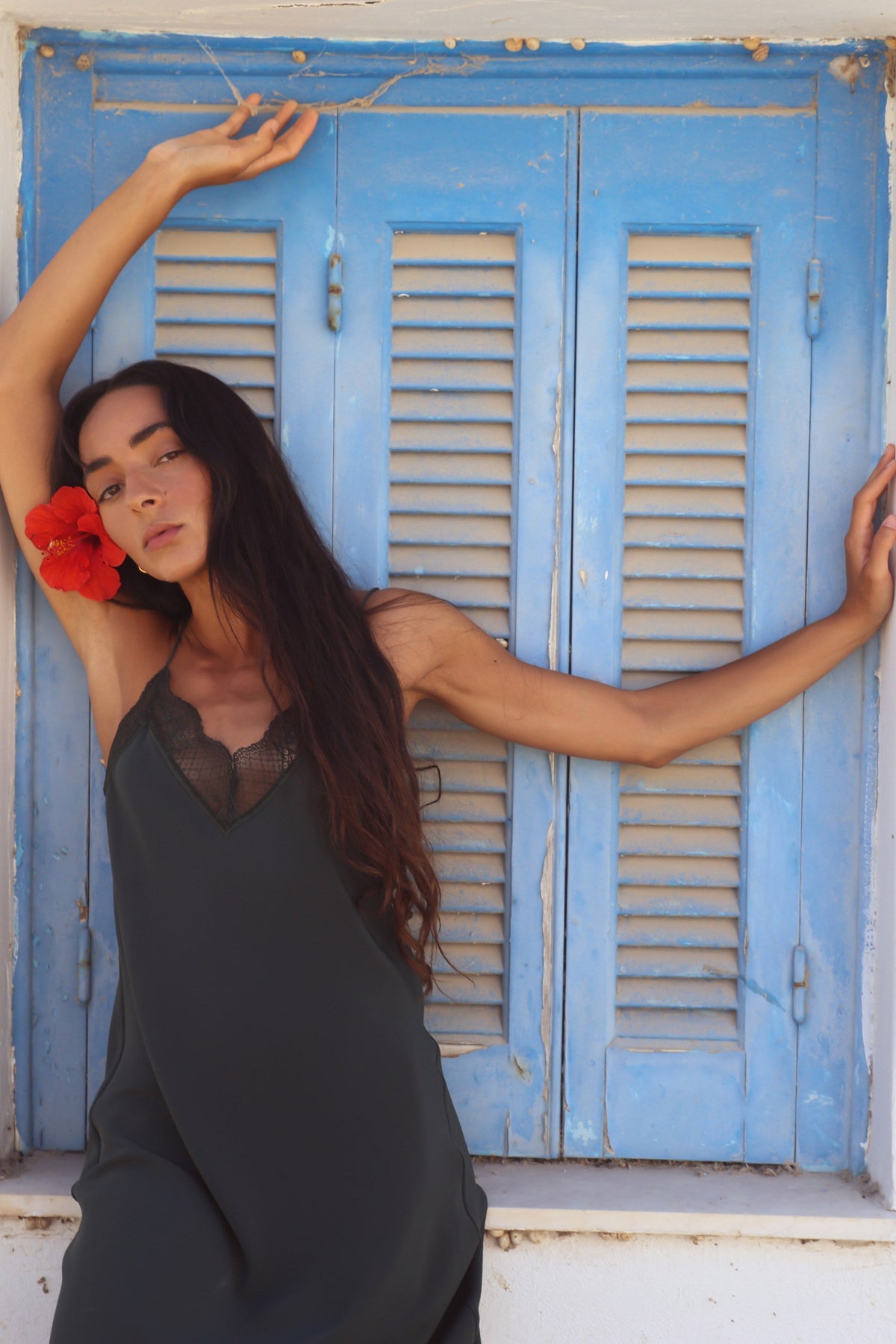 Freya Silk Midi Slip Dress in Forest Green - model with arms raised showing lace neckline and fluid silk drape - Lilly Pilly Collection