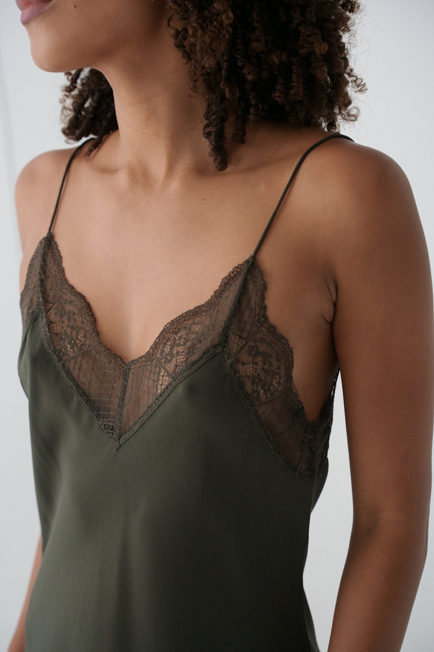Khaki Freya silk slip worn by a model against a neutral background