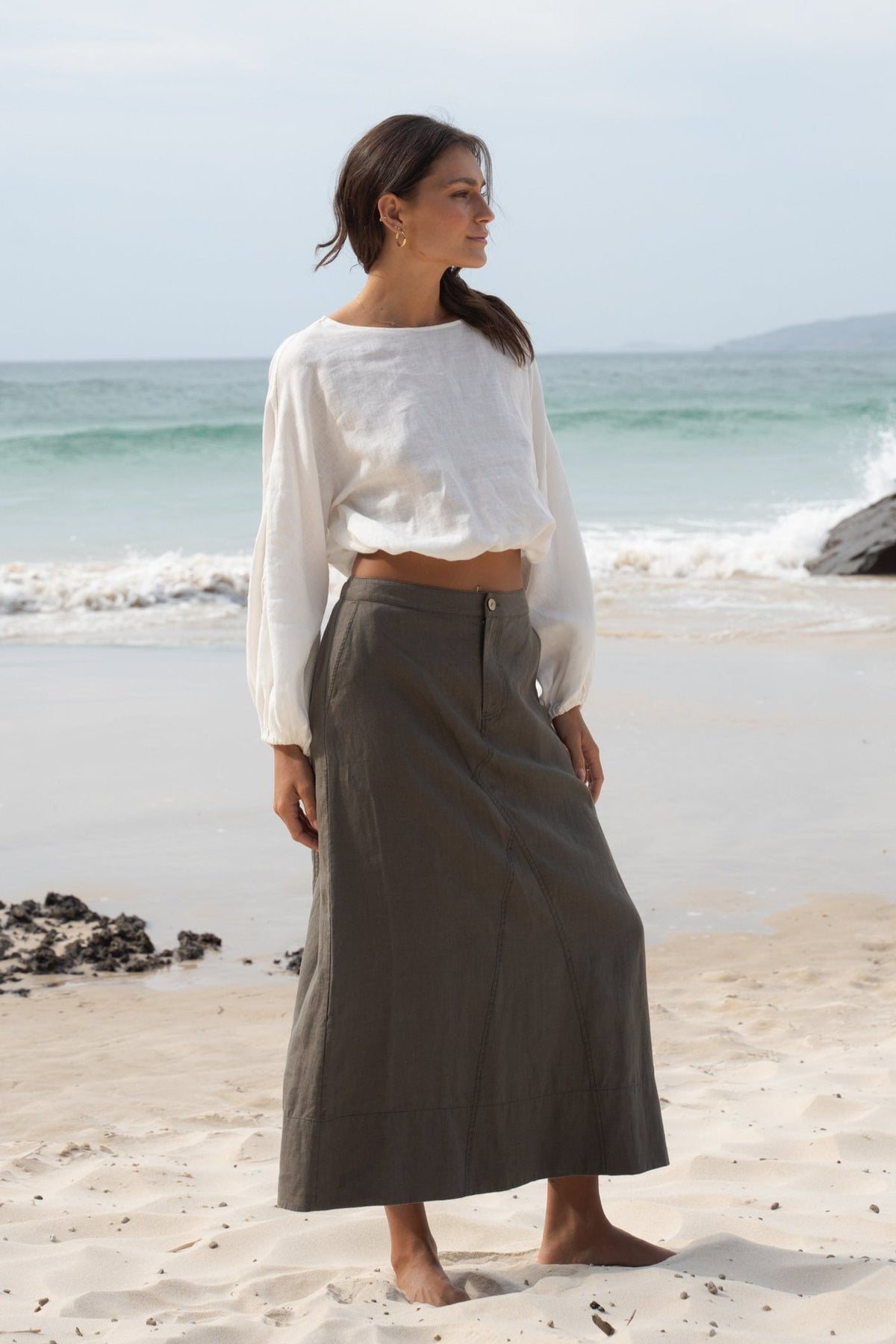 LILLY PILLY Gia linen skirt in Khaki on the beach showing side view