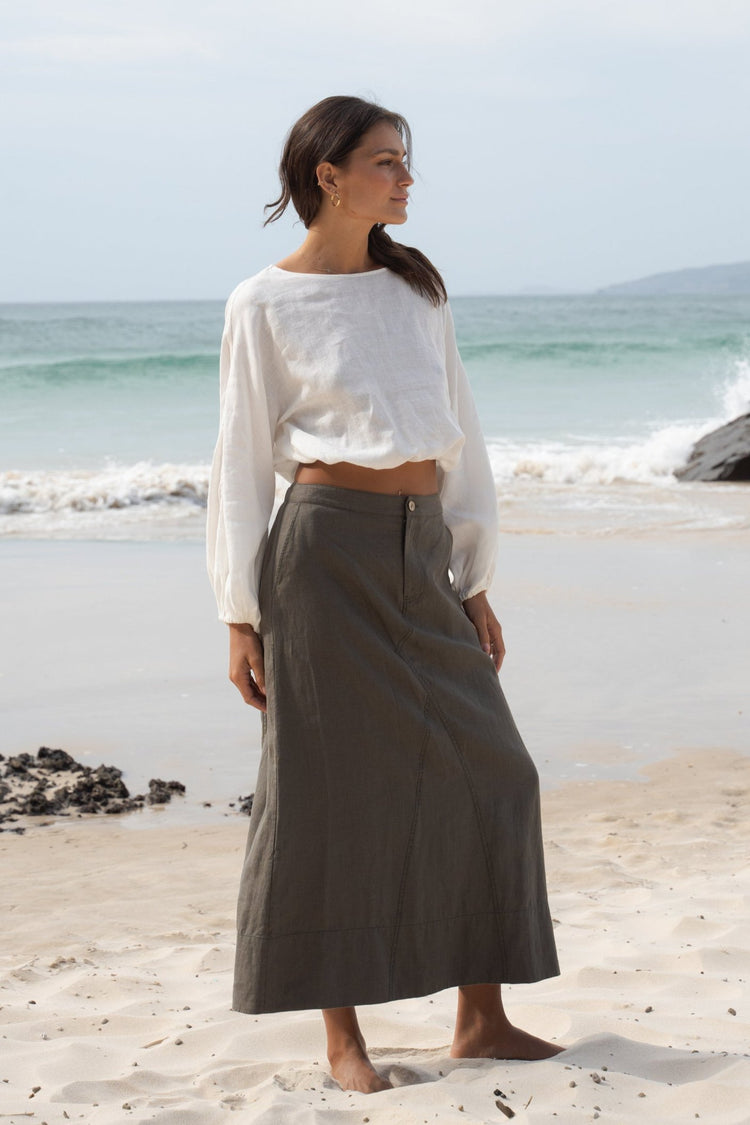 Gia Linen Midi Skirt in Khaki - side view, on the beach - Lilly Pilly Collection