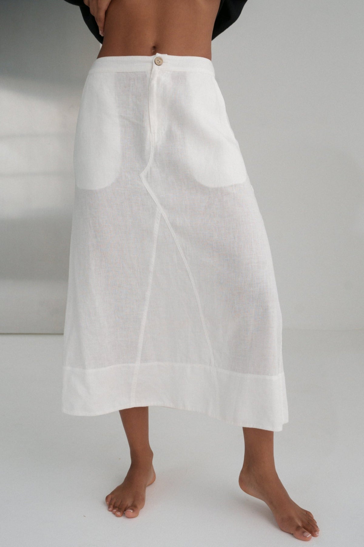 Ivory white Gia linen skirt worn by a person on a plain background
