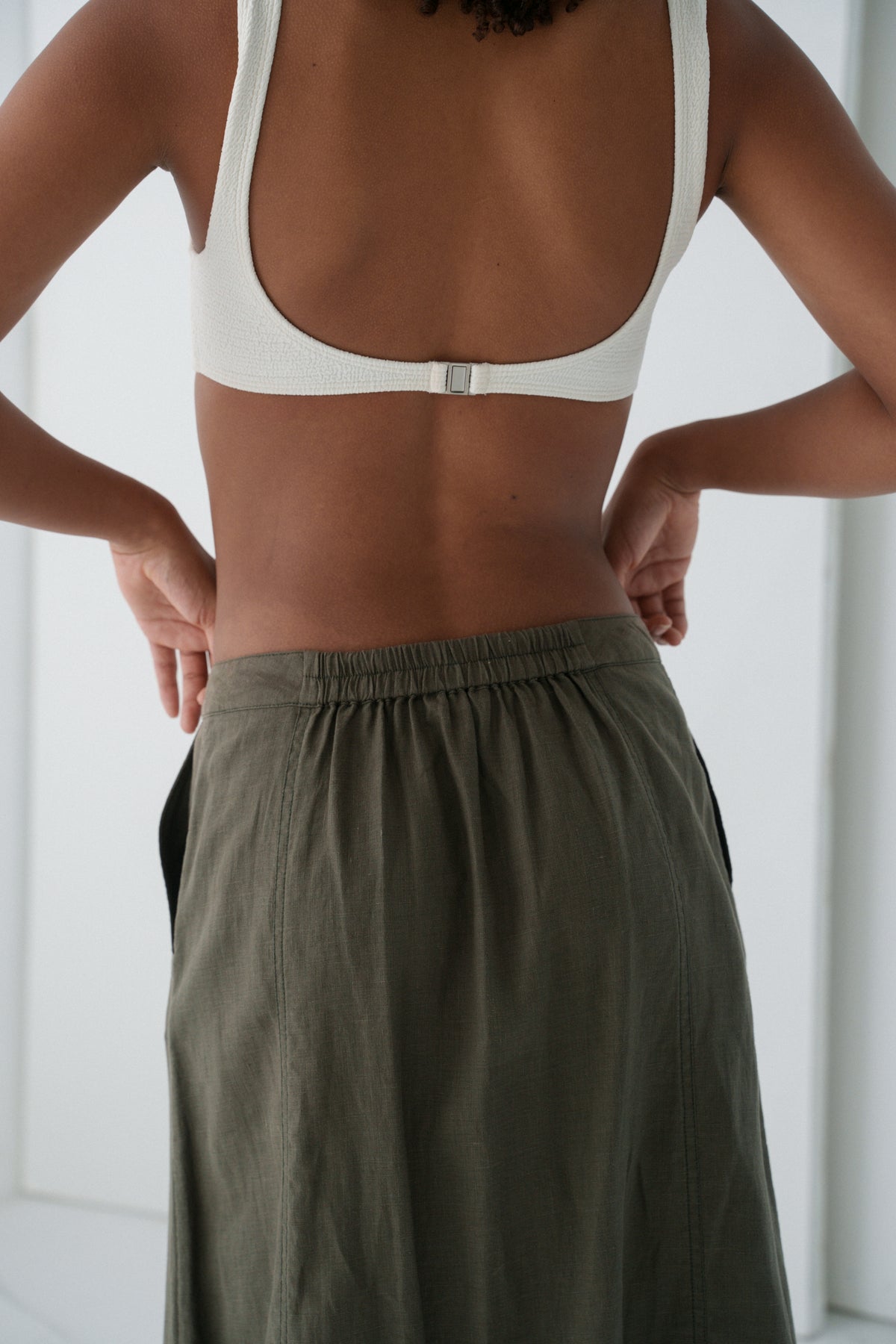 Close up view of waistline details of LILLY PILLY Gia linen skirt in Khaki
