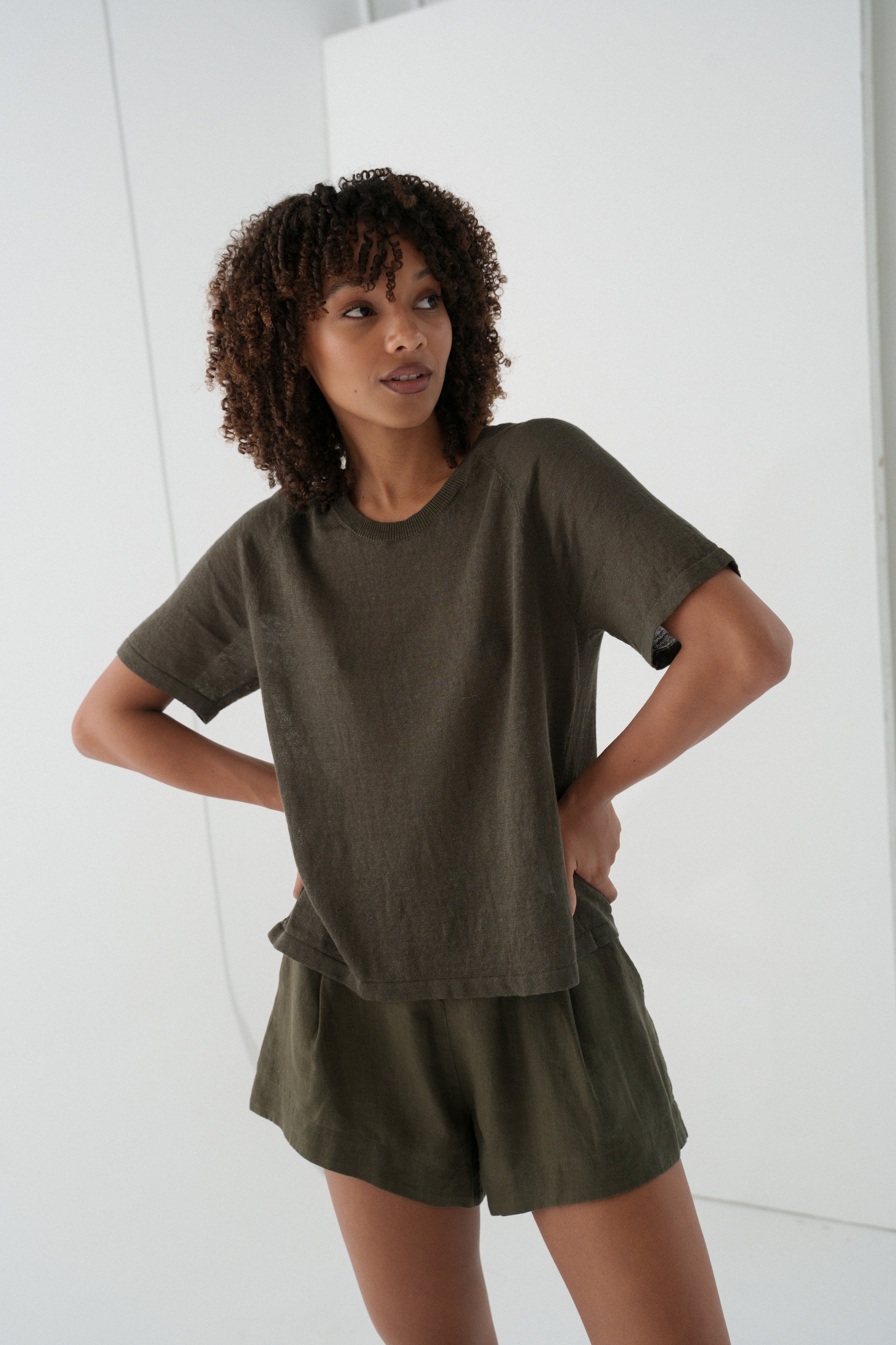 Woman wearing a khaki Grace linen knit top and khaki Gaia linen shorts