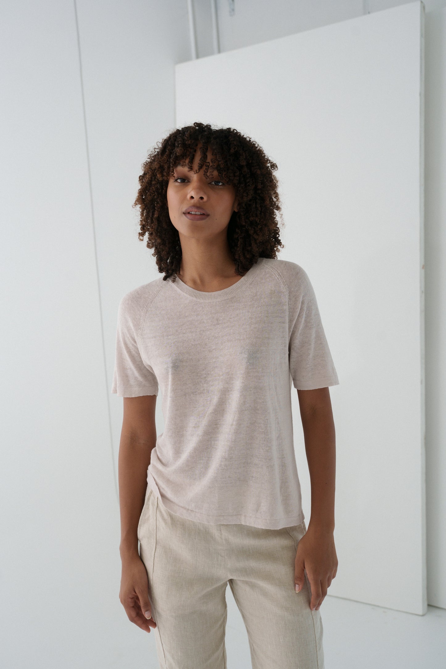 Woman wearing Grace linen knit top and beige linen pants