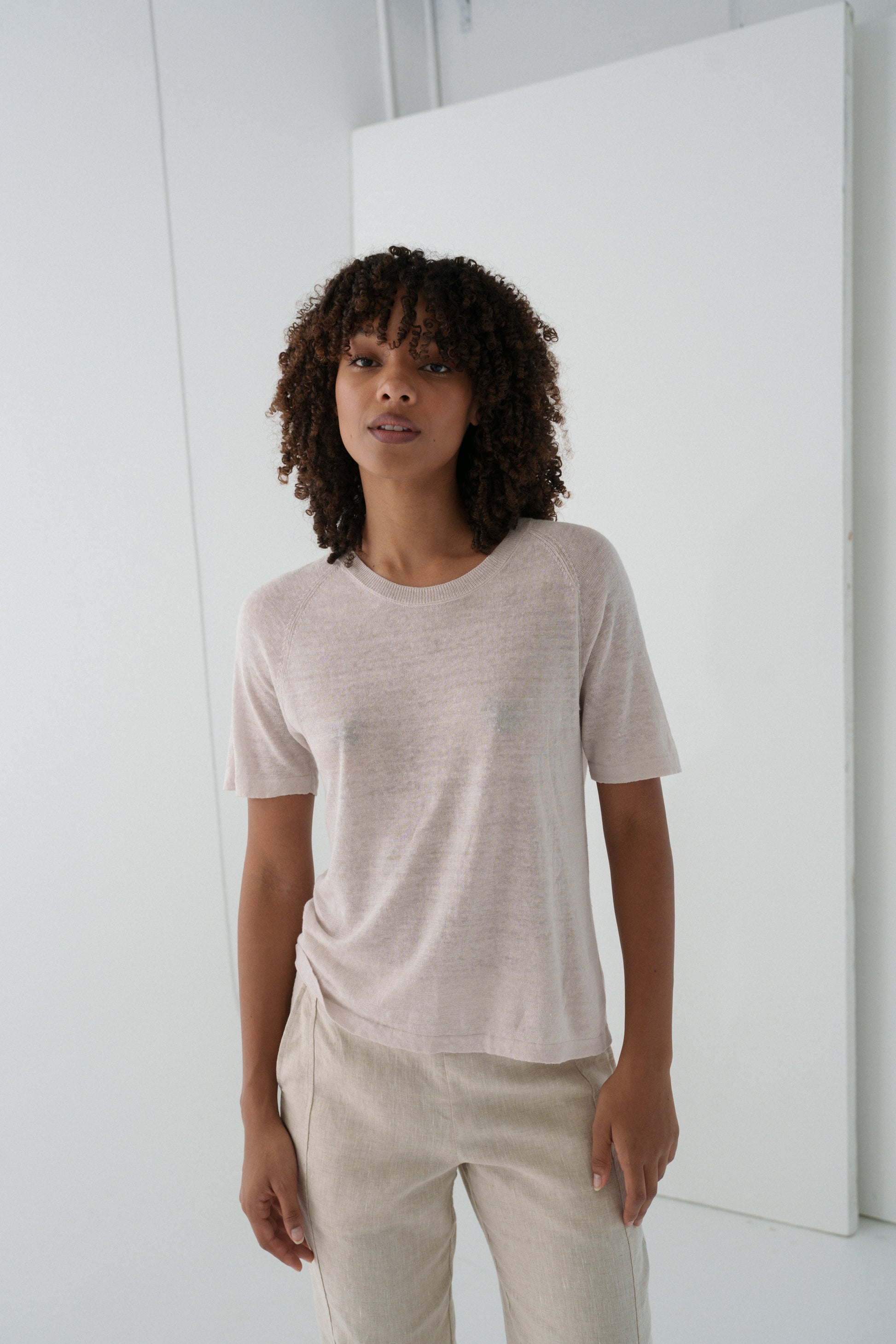 Woman wearing Grace linen knit top and beige linen pants