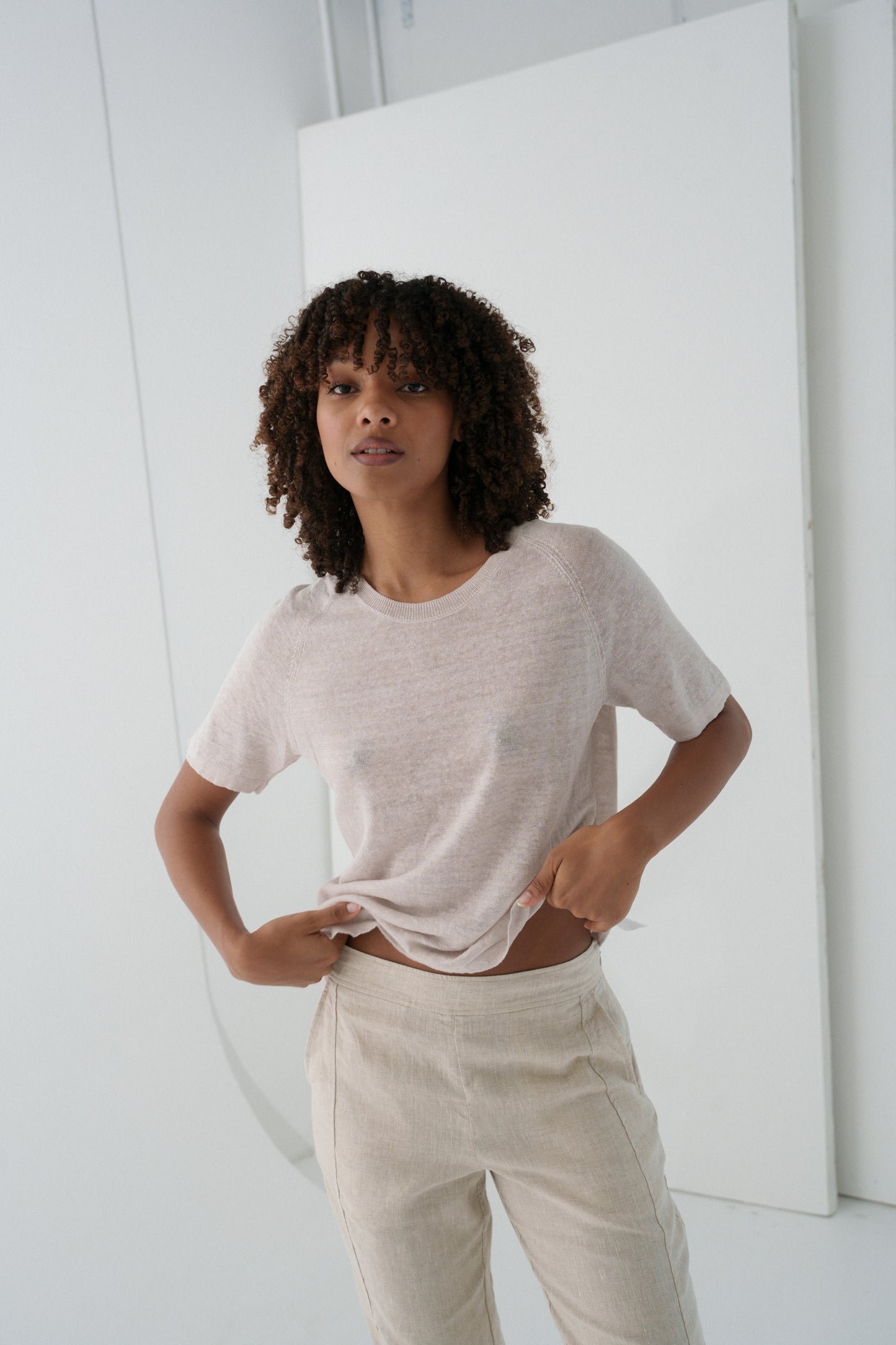 Woman wearing Grace linen knit top and beige linen pants