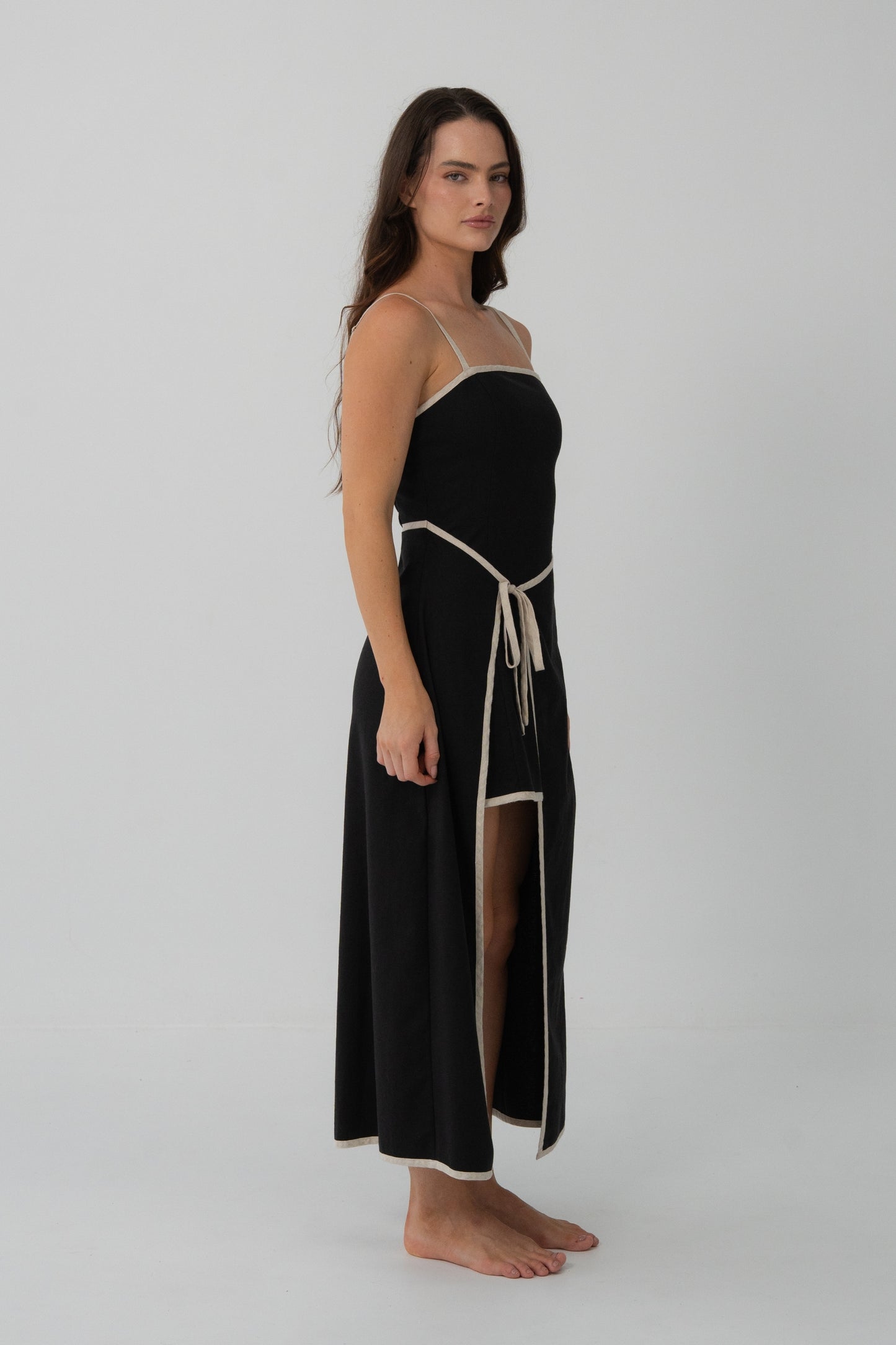 Angle view of Hailey Linen midi dress in Black with oatmeal binding in studio - Lilly Pilly Collection
