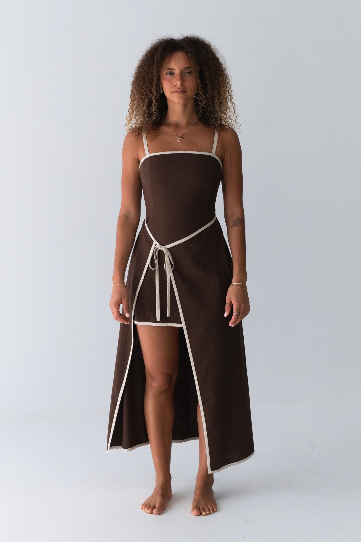 Woman in Hailey Linen midi dress in Chocolate standing in studio setting - Lilly Pilly Collection