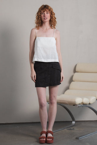 Ilaria Linen Mini Skirt in Black - front view, worn with Rosa Linen Cami in Ivory, studio setting - Lilly Pilly Collection