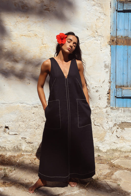 Woman in Iris Linen sleeveless midi dress, black with white contrast stitching — Lilly Pilly Collection