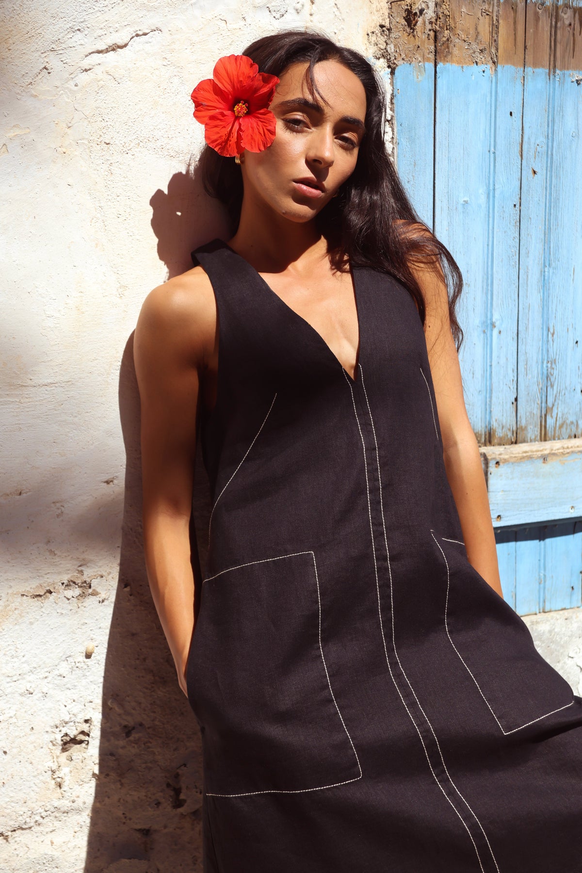 Close up of woman in Iris Linen sleeveless midi dress, black with white contrast stitching — Lilly Pilly Collection