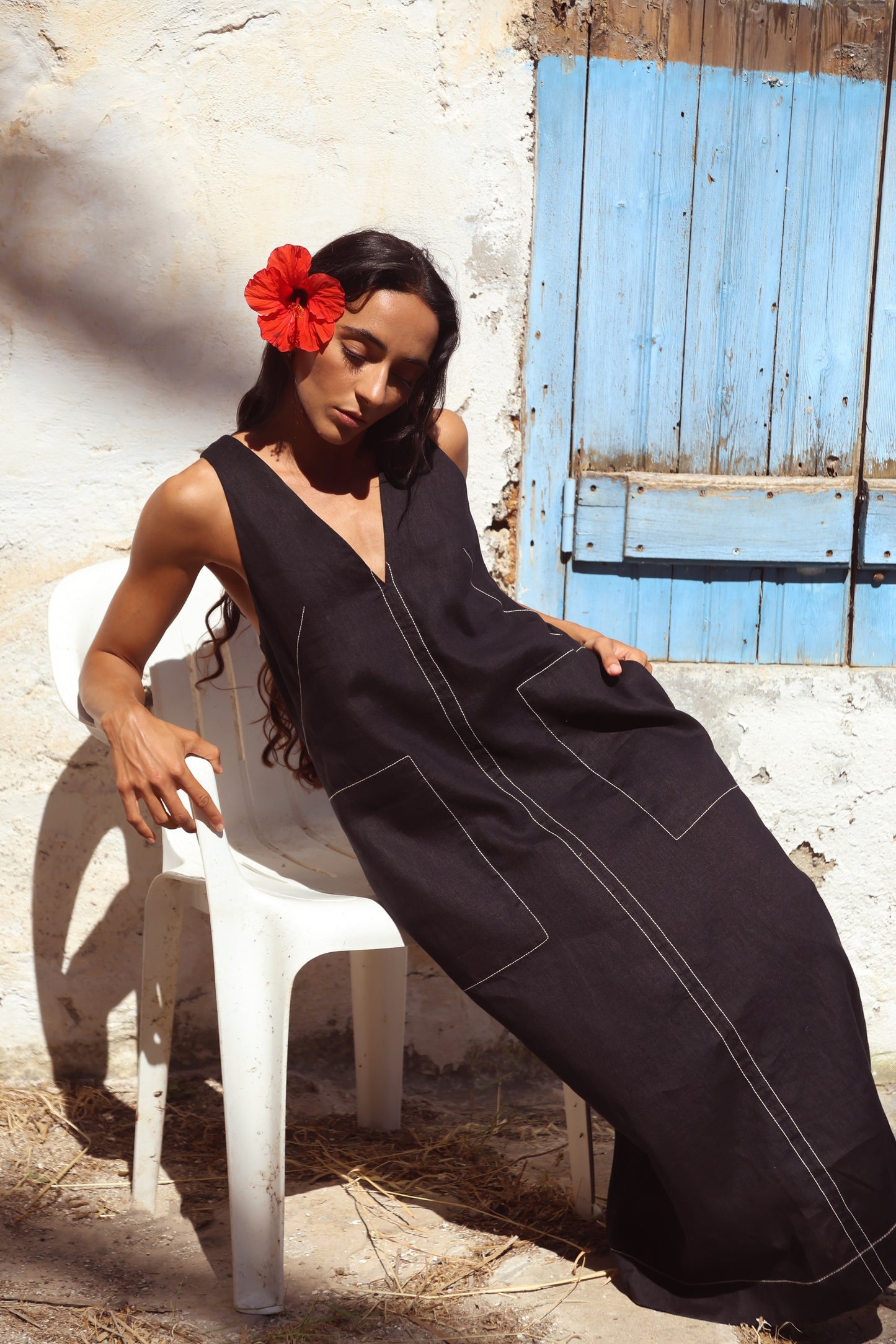 Woman in Iris Linen sleeveless midi dress, black with white contrast stitching, full view — Lilly Pilly Collection
