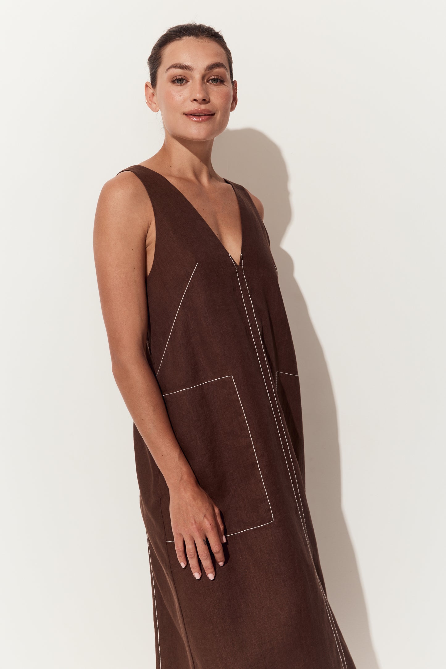 Iris Linen Midi Dress in Chocolate - three quarter view of dress with a deep V-neck, hands by side - Lilly Pilly Collection
