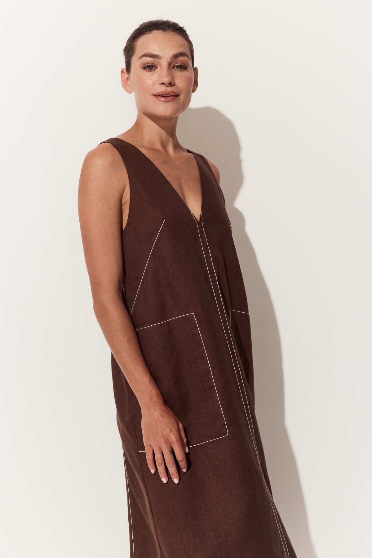 Iris Linen Midi Dress in Chocolate - three quarter view of dress with a deep V-neck, hands by side - Lilly Pilly Collection