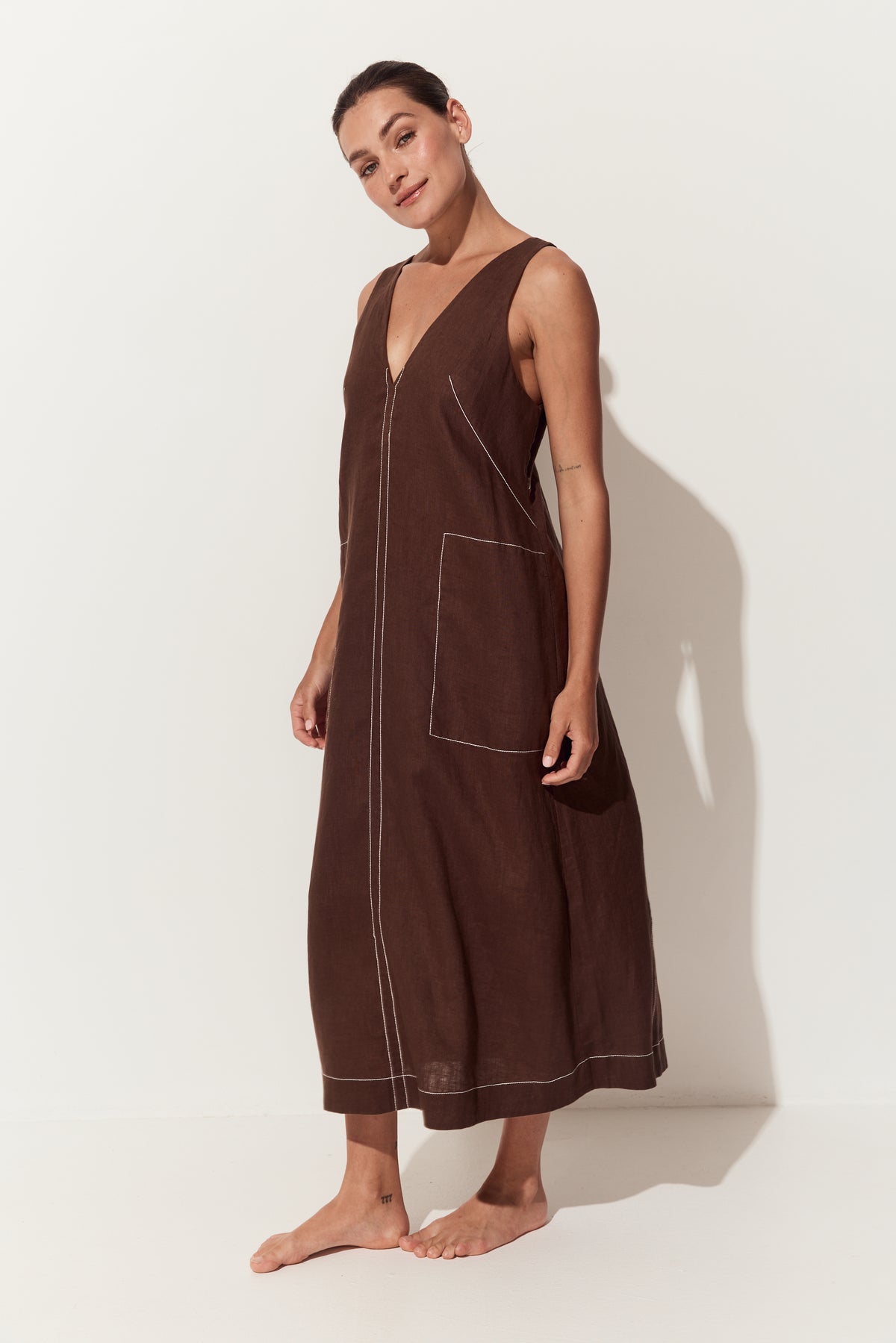 Iris Linen Midi Dress in Chocolate - three quarter view of dress with a deep V-neck, large front patch pockets - Lilly Pilly Collection