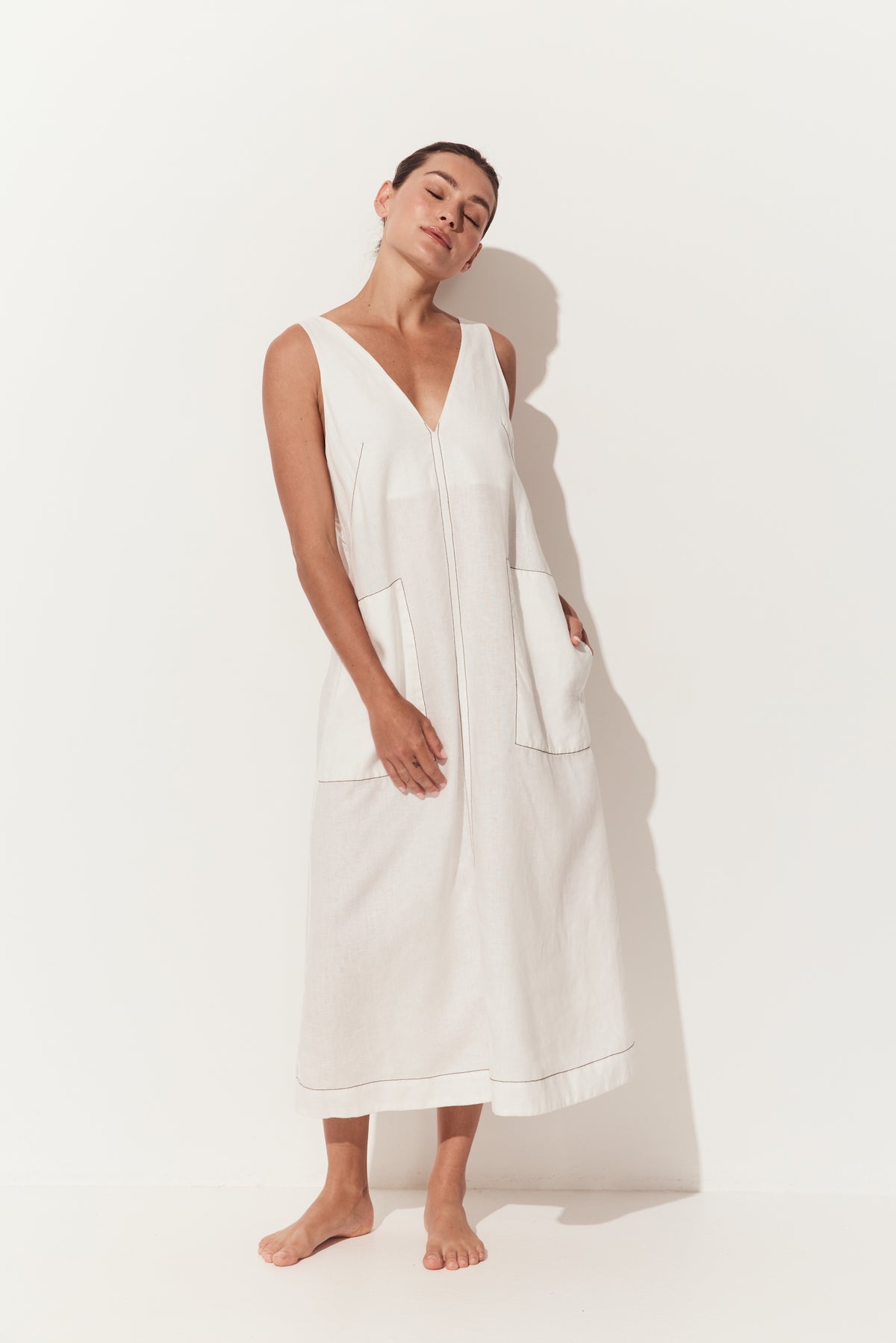 Iris Linen Midi Dress in Ivory and Chocolate - full front view of sleeveless ivory white linen midi with chocolate stitching details and a deep V-neckline - Lilly Pilly Collection