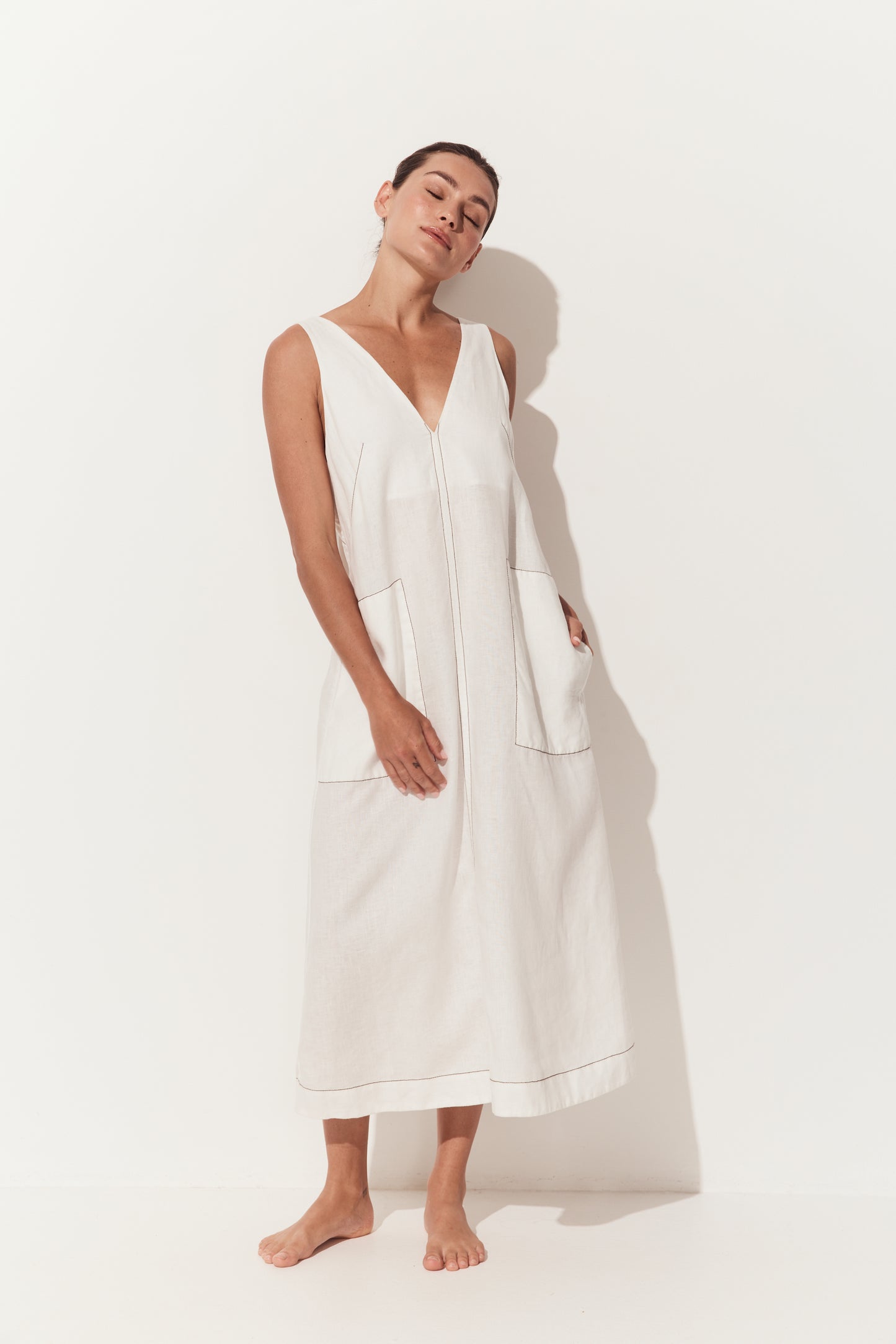 Iris Linen Midi Dress in Ivory and Chocolate - full front view of sleeveless ivory white linen midi with chocolate stitching details and a deep V-neckline - Lilly Pilly Collection