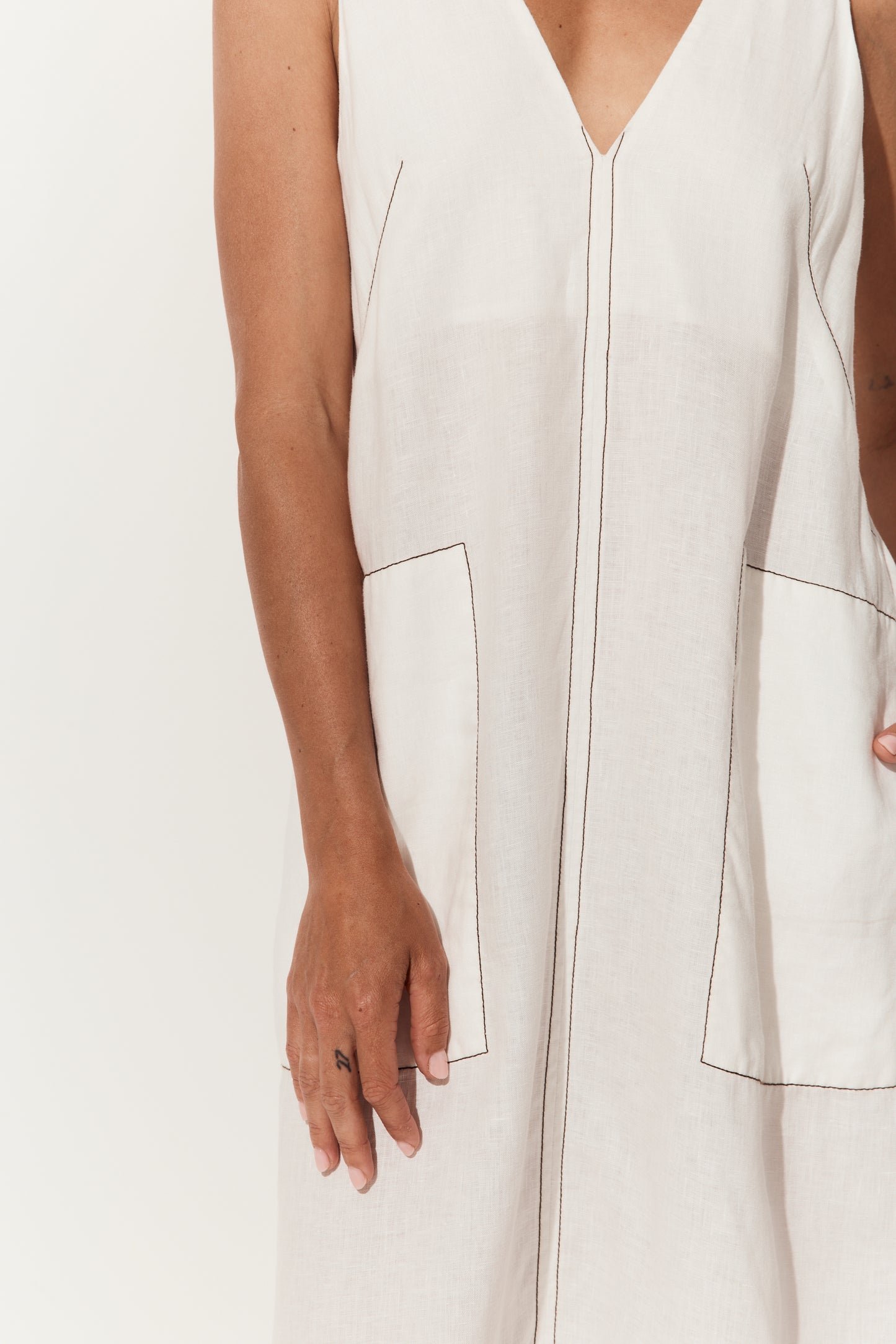 Iris Linen Midi Dress in Ivory and Chocolate - close up of pockets with chocolate stitching details - Lilly Pilly Collection