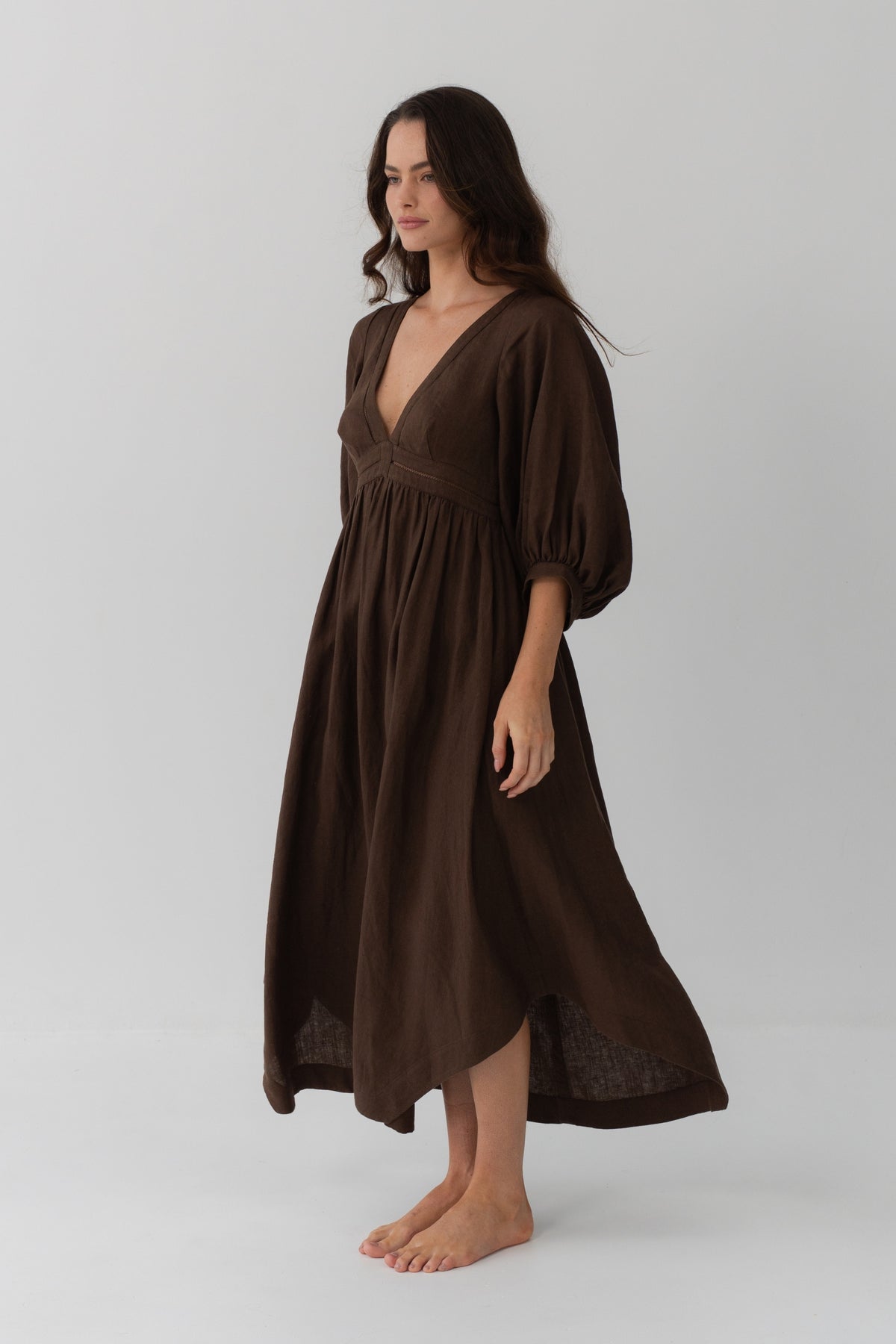 Josie Linen Midi Dress in Chocolate - three-quarter view showing flowy skirt and puff sleeve volume - Lilly Pilly Collection