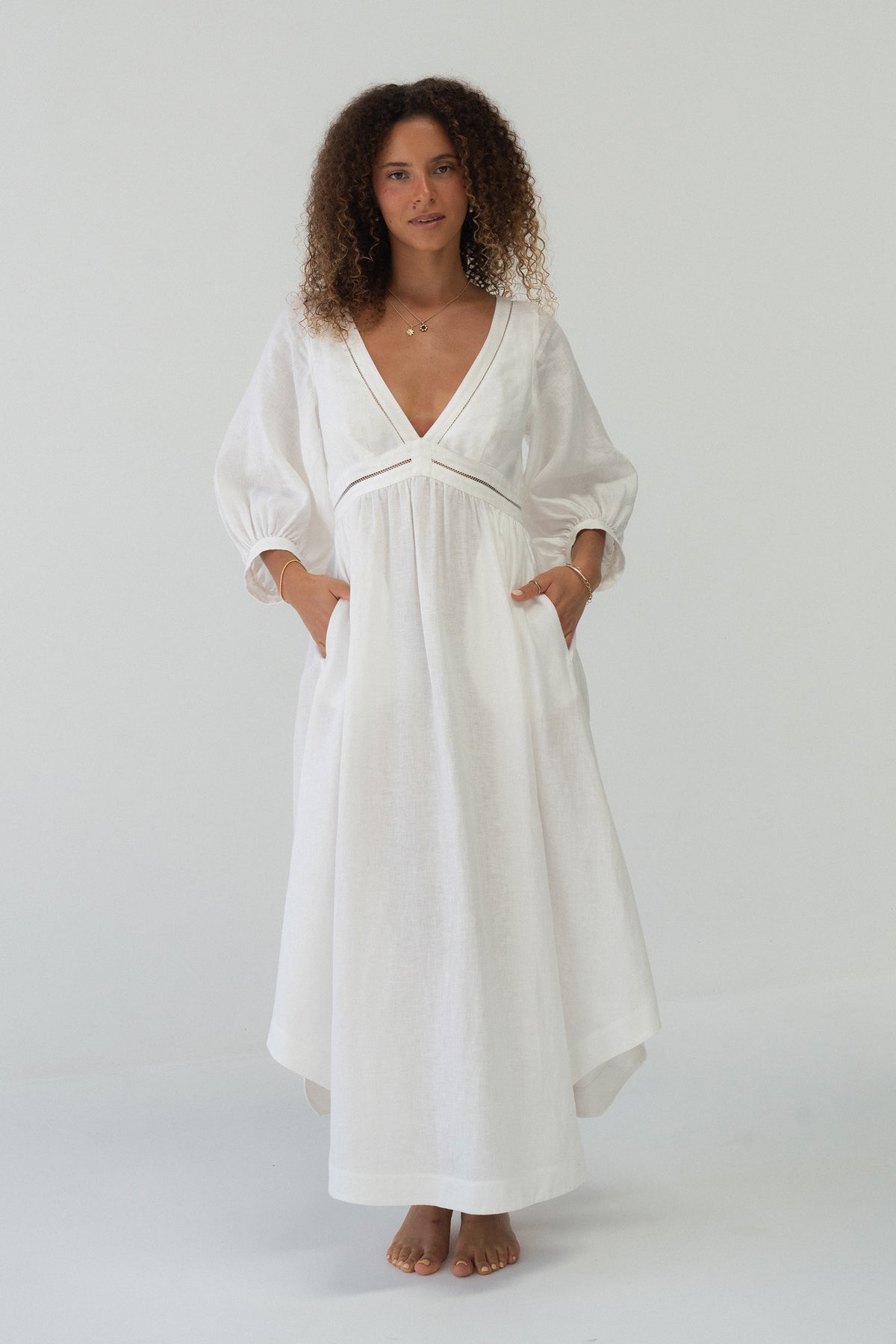Josie Linen Midi Dress in Ivory - front full-length view with deep V-neckline and side pockets - Lilly Pilly Collection