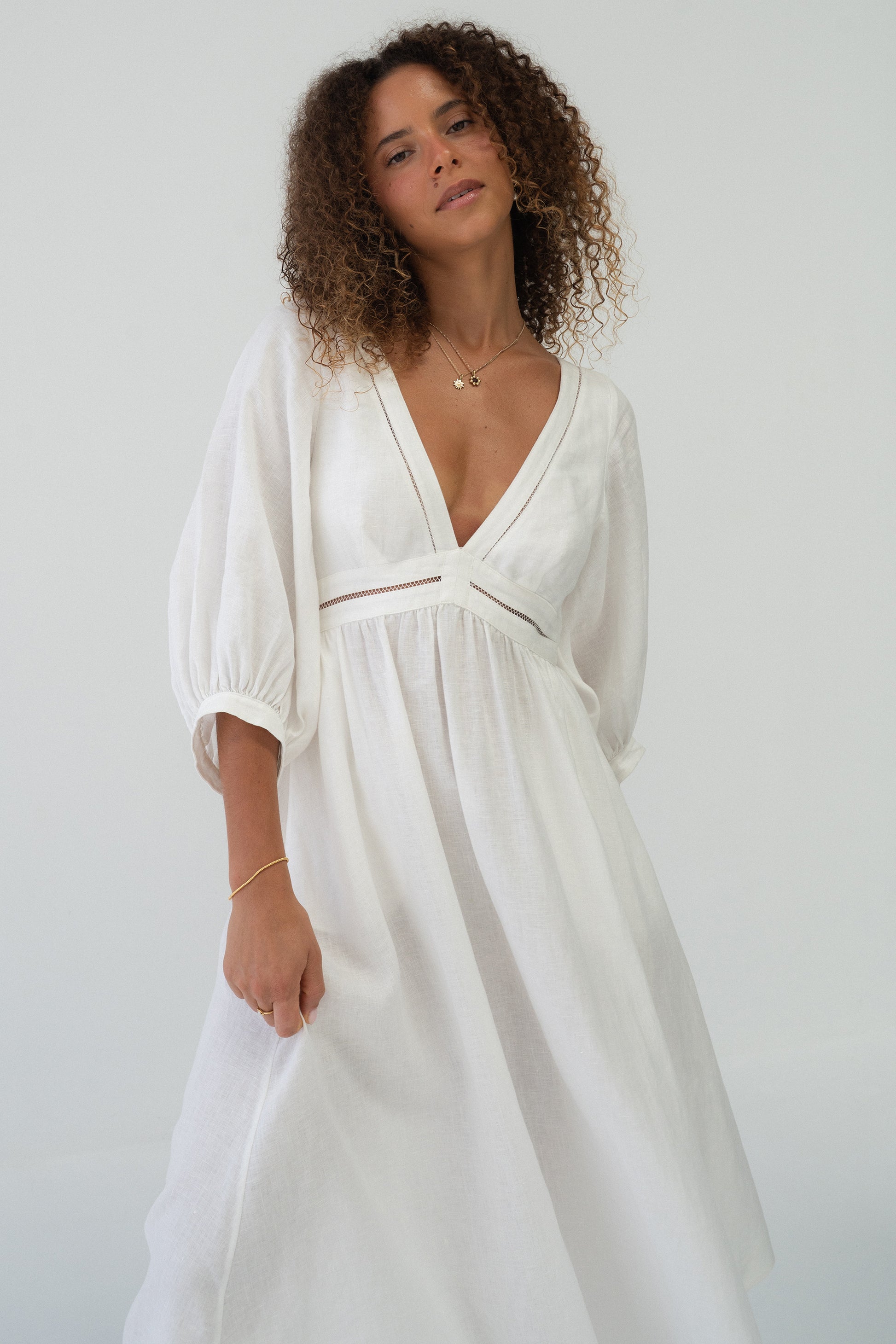 Josie Linen Midi Dress in Ivory - three-quarter front view showing gathered skirt and puff sleeves - Lilly Pilly Collection