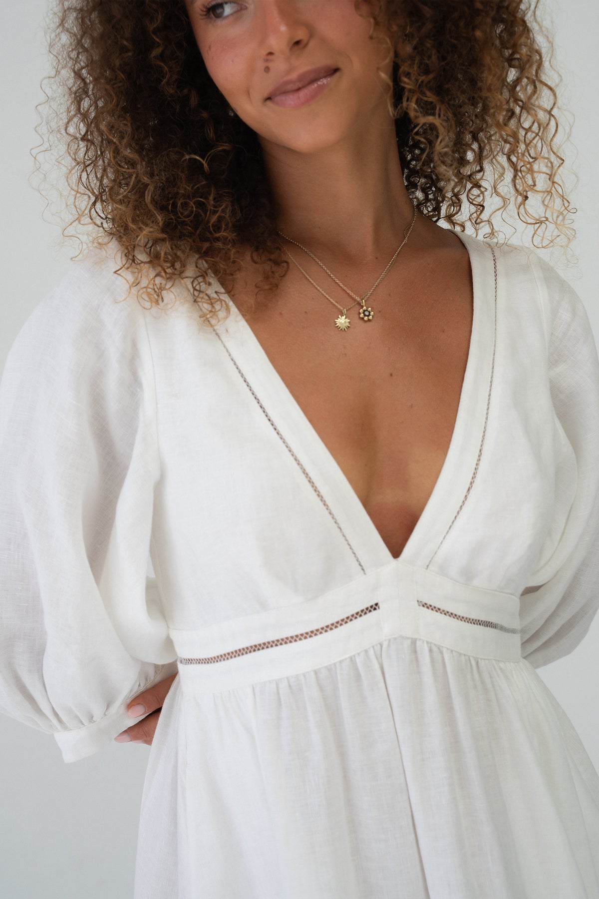 Josie Linen Midi Dress in Ivory - close-up of deep V-neckline and ladder lace waist trim detail - Lilly Pilly Collection